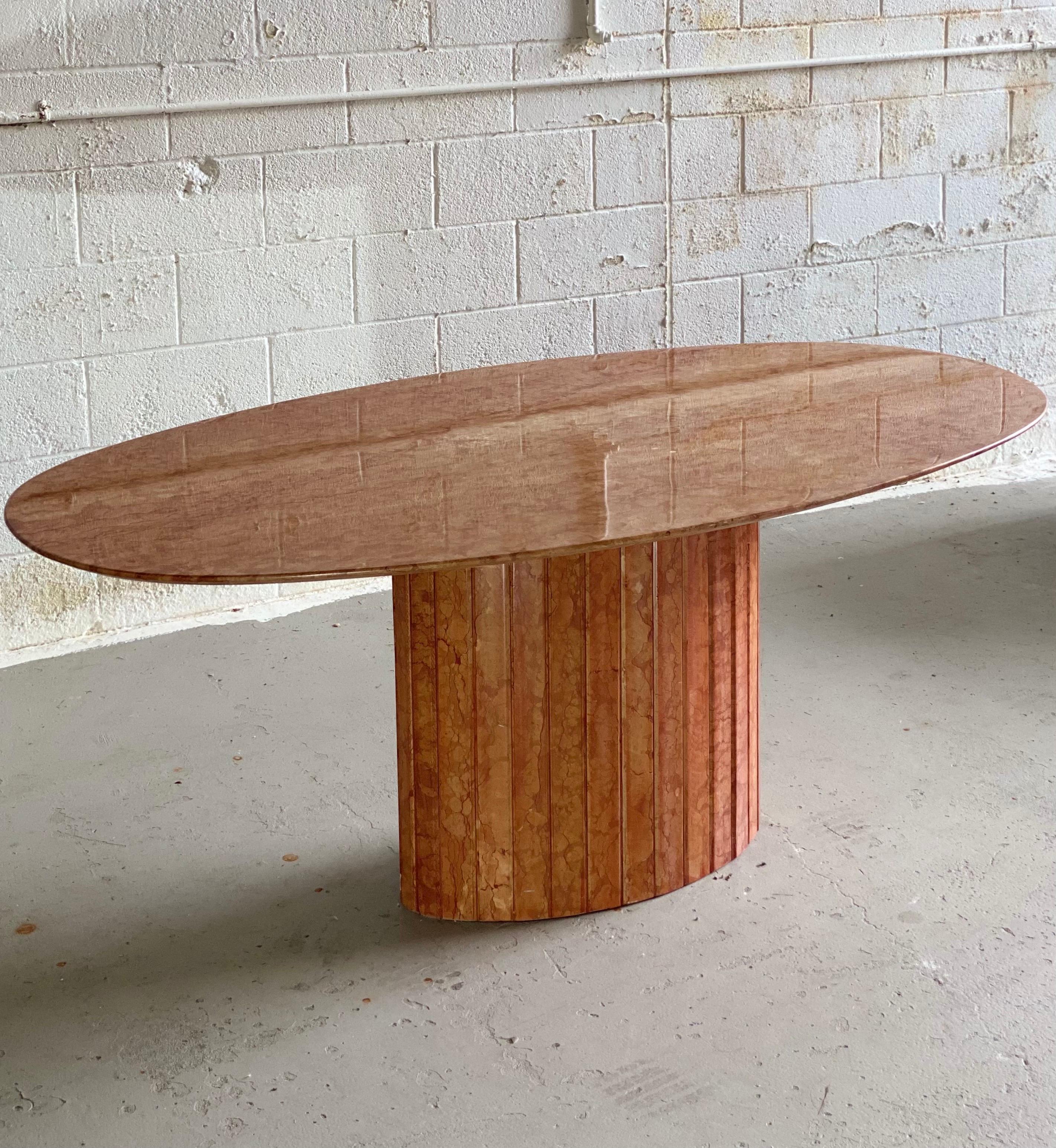We are very pleased to offer a sculptural, lacquered marble dining table, made in Italy, circa the 1970s. This timeless piece poses a visual effect from every point of view and showcases the stone’s natural beauty of its veins. Its simple form and