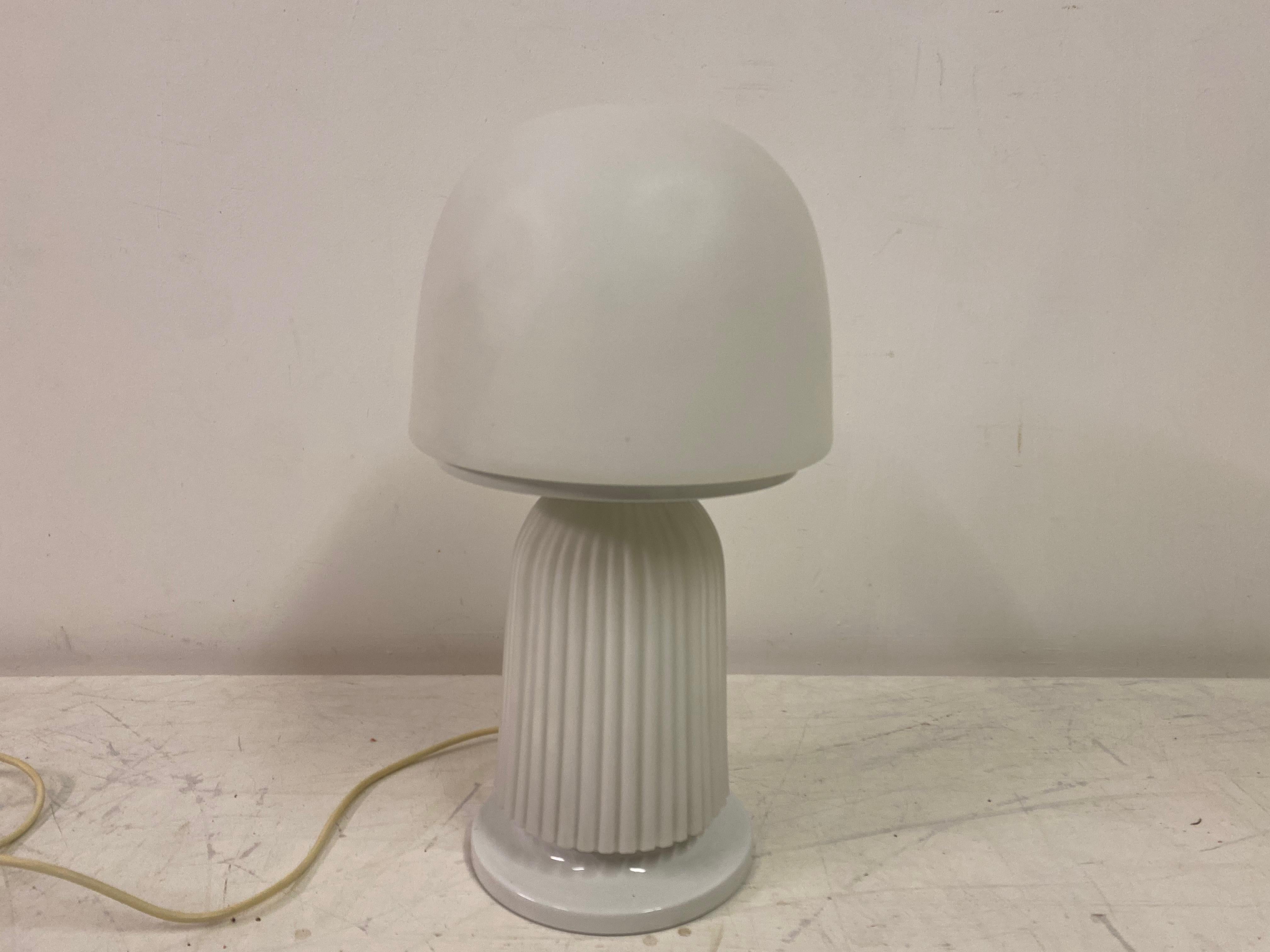Mushroom lamp

White glass

Ribbed body

White painted metal base

Italy 1970s.