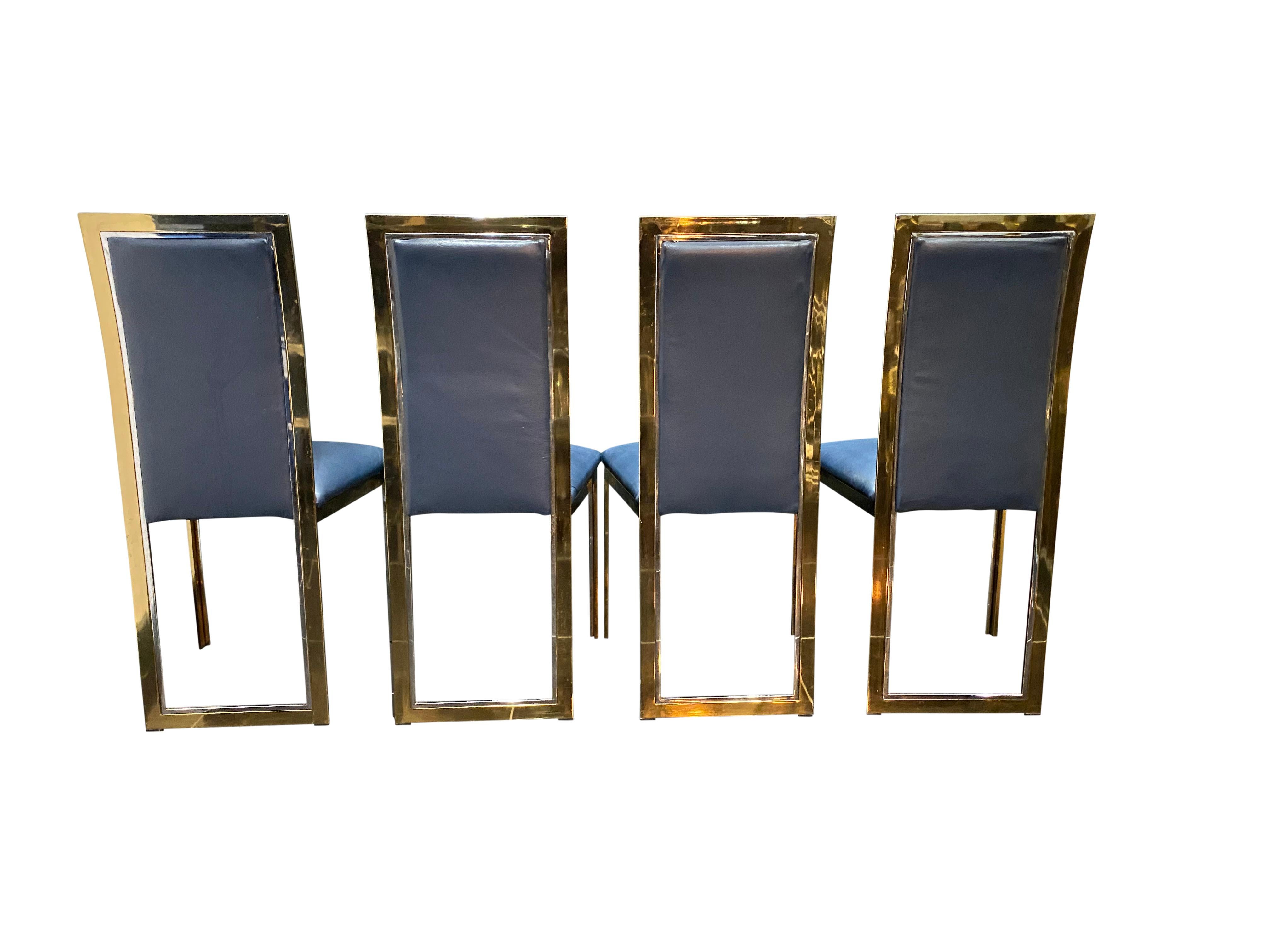 A set of four dining chairs by Romeo Rega in bi-metal upholstered in navy leather.


  