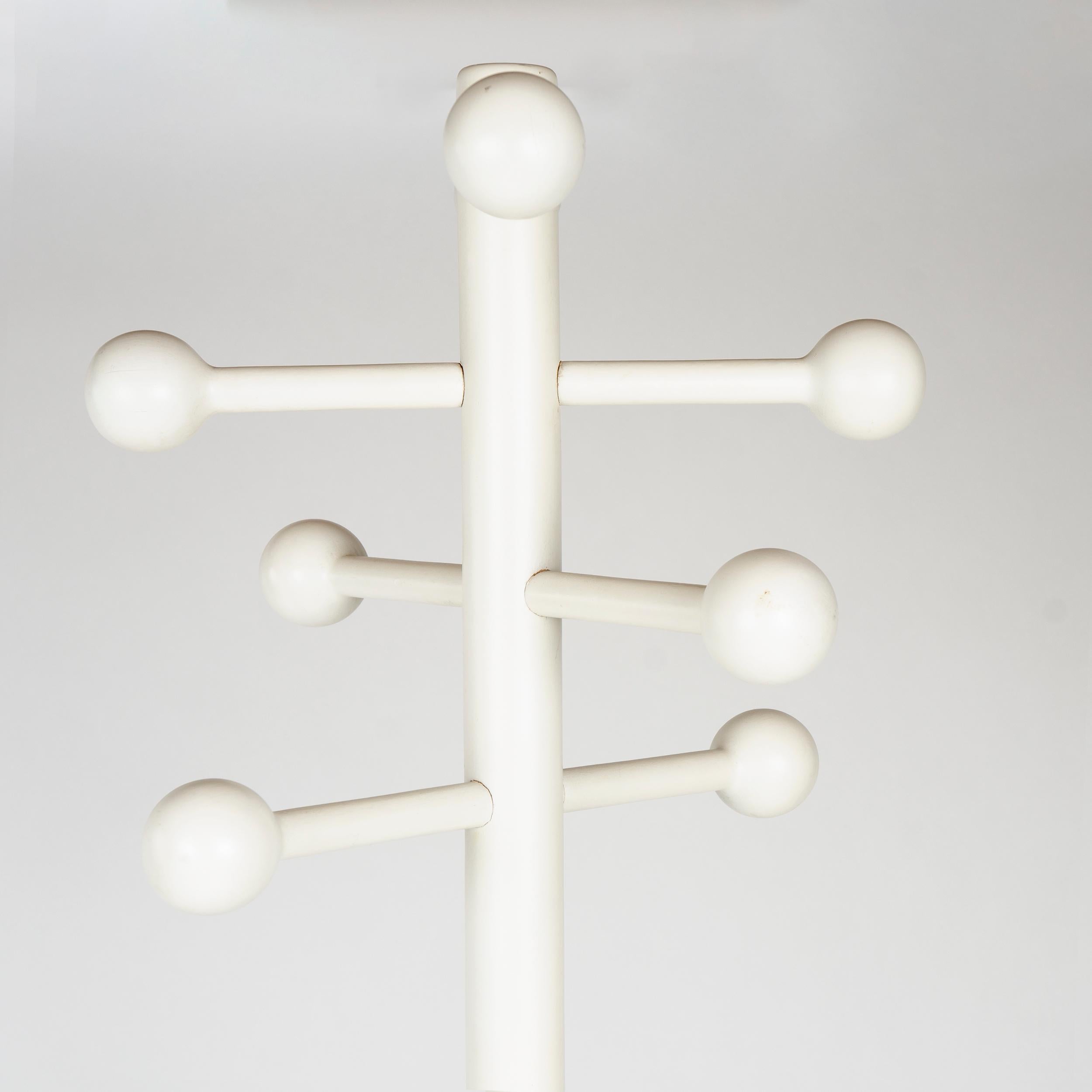 Solid wood coat tree with numerous curved hooks each with a wooden ball at its end. This unit is in its original white enamel but when new black, yellow, and olive green were also available. Marked under one leg ‘Made in Italy’ and ‘Manzano’ which
