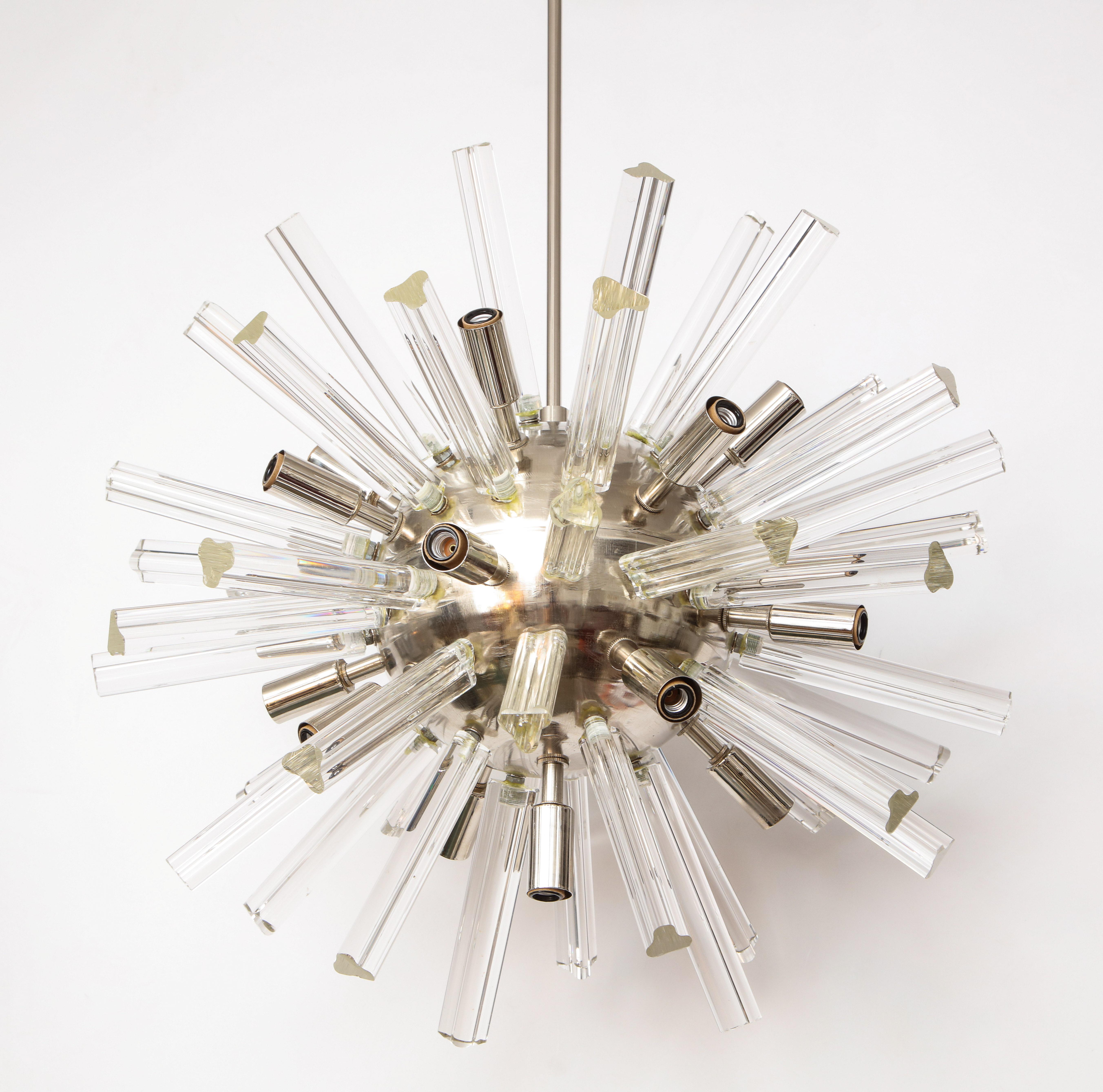 1970s Italian sputnik chandelier.
The large chrome ball supports the Murano glass prisms
that are illuminated by the newly rewired candelabra light sockets.
 