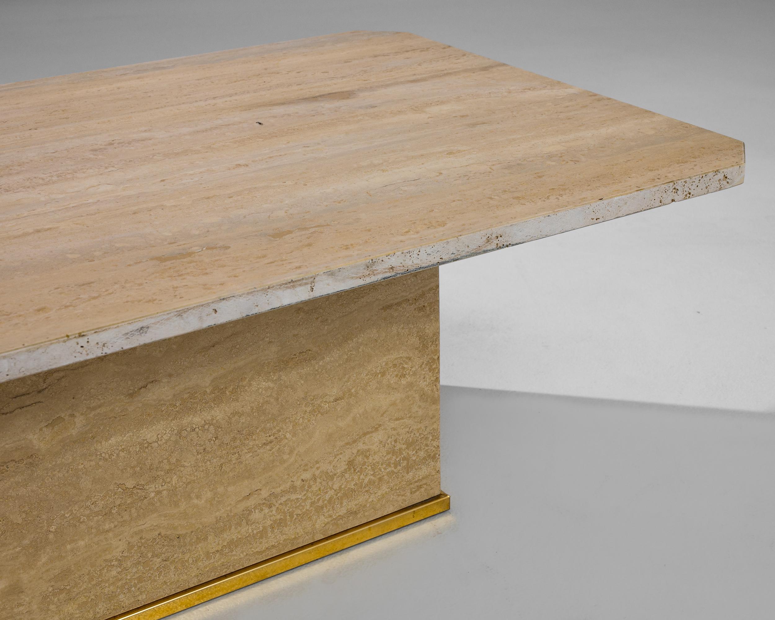The formal simplicity and beautiful color of this travertine marble coffee table create an impression of minimalist luxury. Made in Italy in the 1970s, an oblong tabletop with gently rounded corners sits atop a low rectangle of stone. The butter