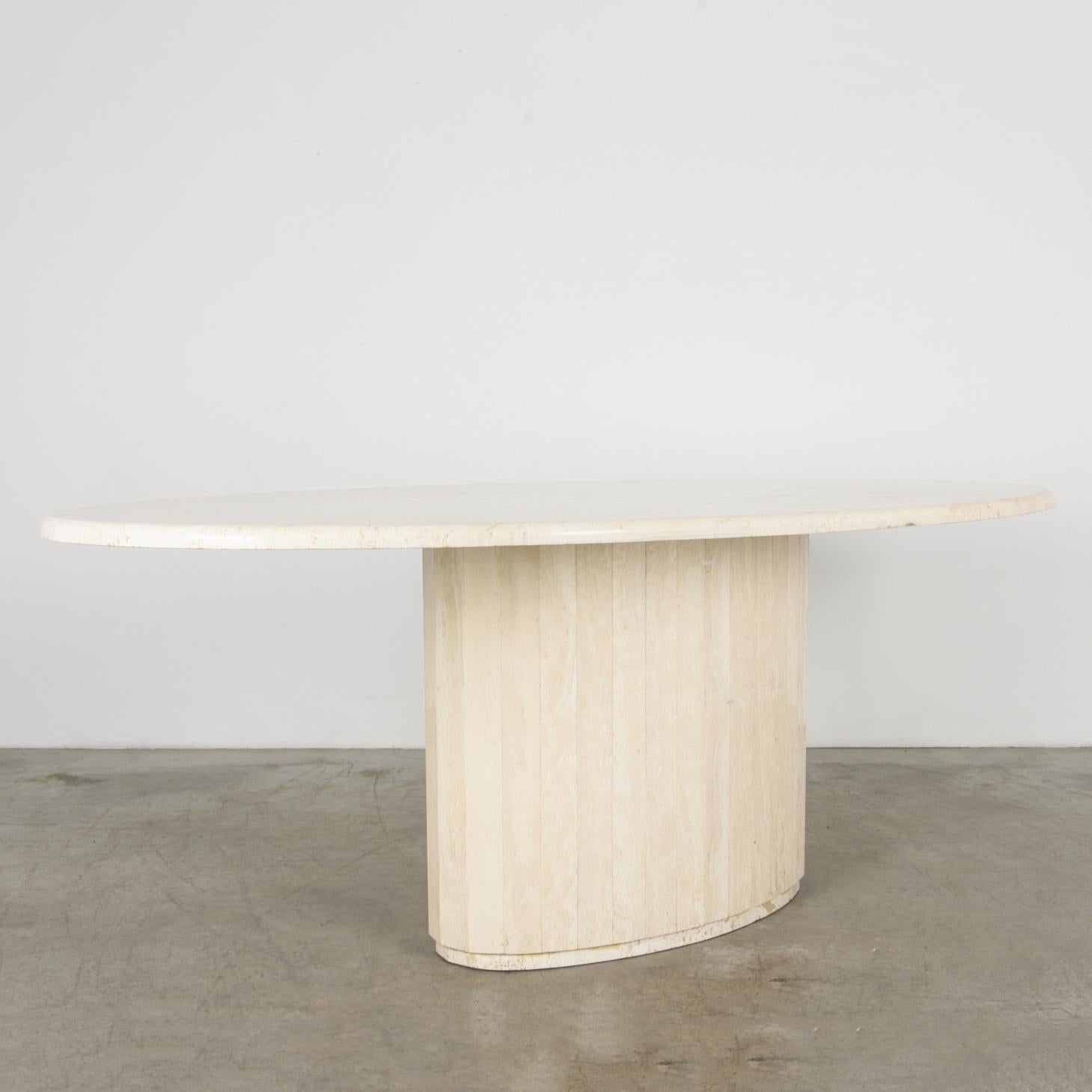 A cantilevered slab of light travertine rests on a faceted round base in this stylish and simple dining table. The tabletop is carved with half bullnose edge profile.

Stone is a material rich in itself; echoing classical sculpture, a design that's