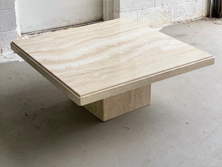 We are very pleased to offer an extraordinary, Italian travertine coffee table, circa the 1970s. This beautiful, architectural piece showcases a square pedestal base and a large square tabletop. In excellent condition consistent with wear and age.