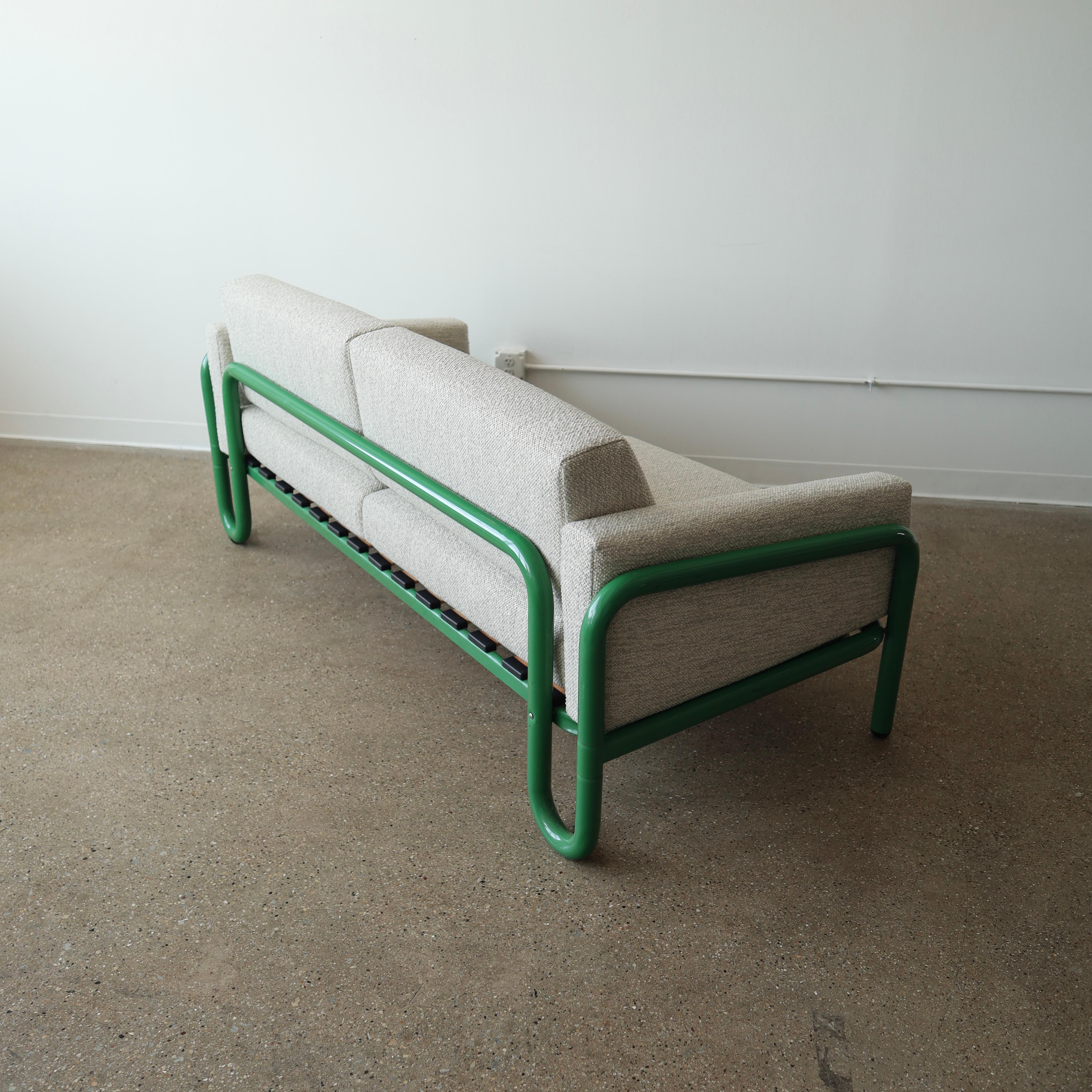 fully restored in a nubby, wool-blend textile with new foam. The frame has wear consistent with age and use including scuffs, scratches, and paint use 

