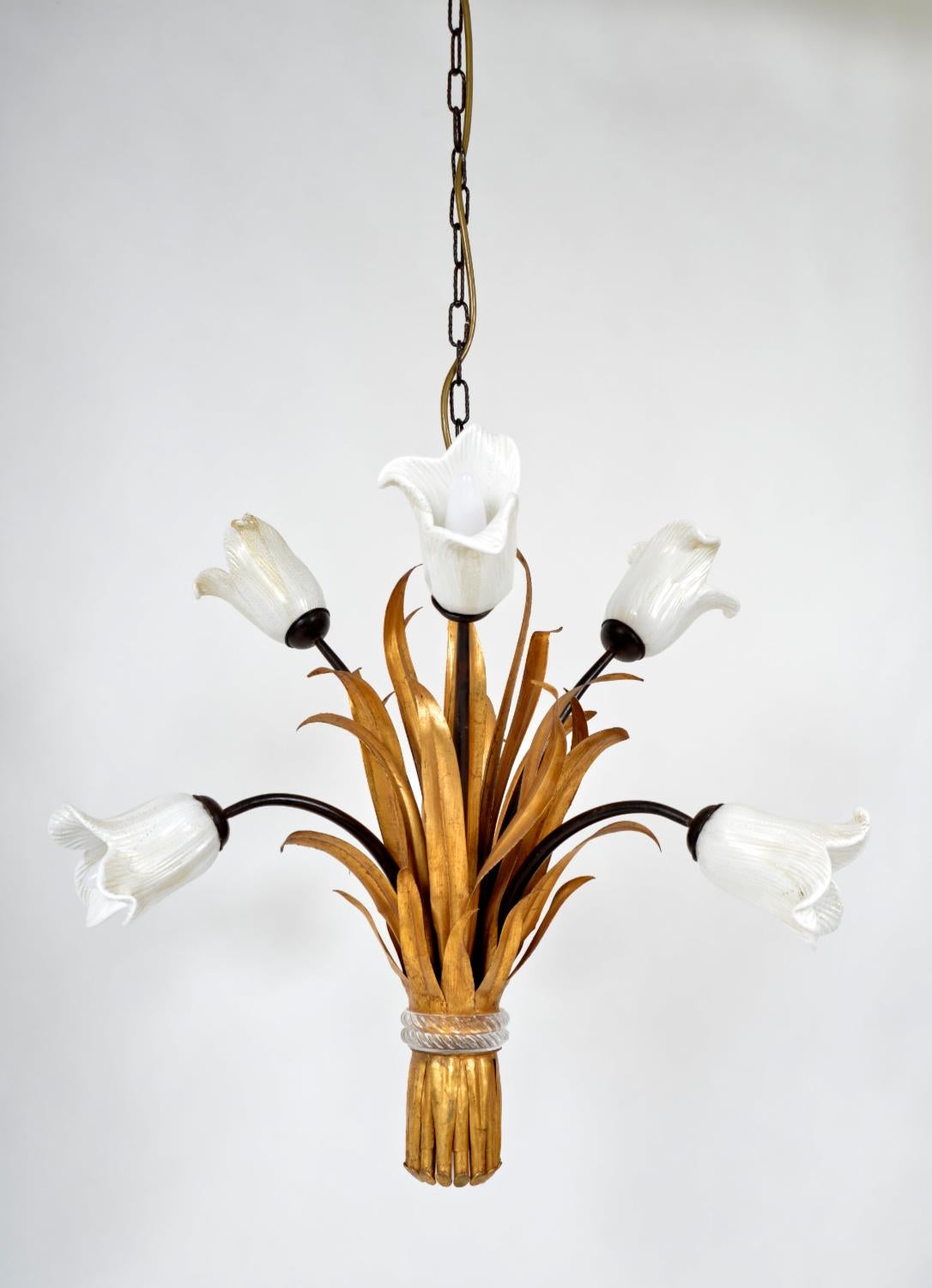 A stunning late 1970s Italian gilt toleware and glass chandelier by Banci of Florence, Italy from the ‘Tulipani’ Collection. 
Six beautifully sculptured, white Murano glass tulips embellished with golden spots perch on black metal stems, which