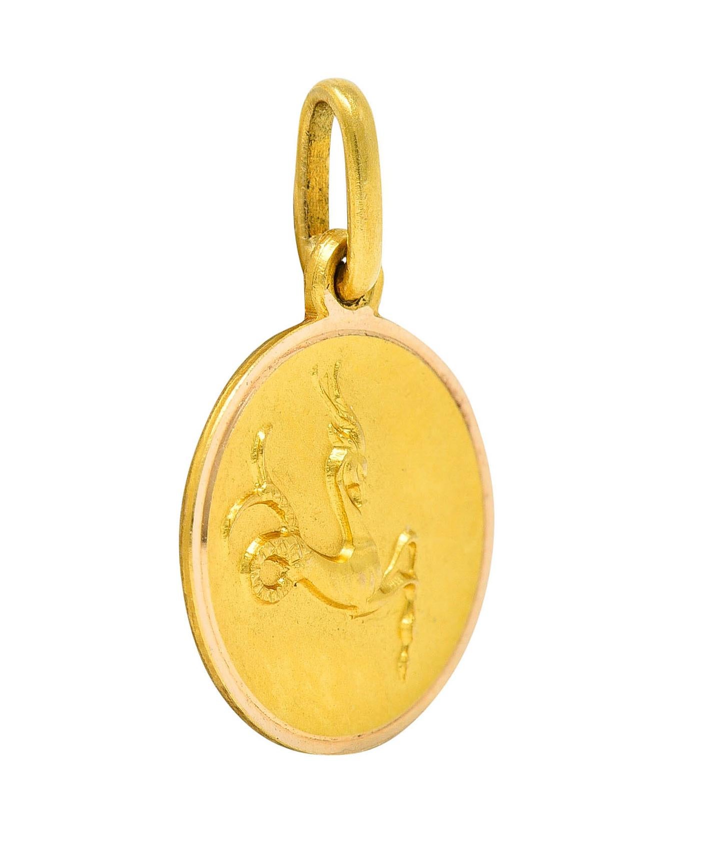 Circular charm has a matte finish and a raised rendering of capricorn

Zodiac figure depicted as a stylized goats head with fish tail 

Raised high polish frame

Italian assay marks for 18 karat gold

Circa: 1970's 

Measures: 7/16 x 11/16 inch