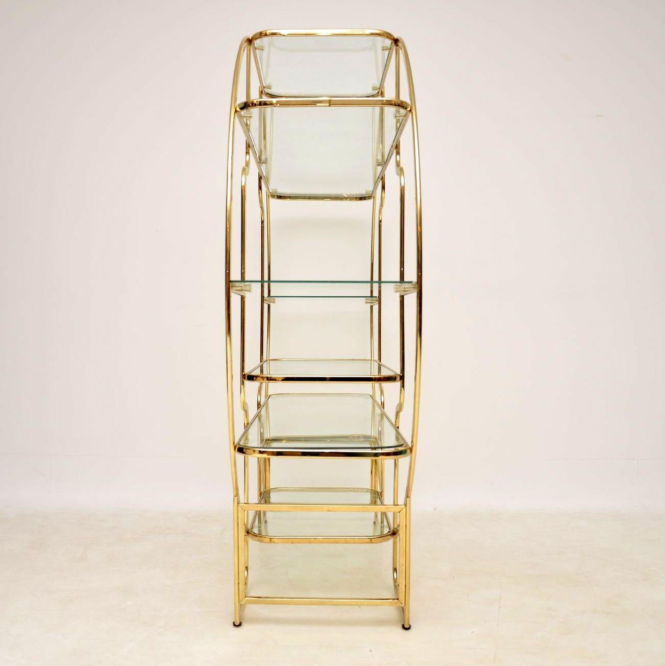 A stunning and very well made vintage display cabinet in brass with glass shelves, this was made in Italy and dates from the 1970s. It has a beautiful circular design, is finished back and front so can be used as a free standing room divider. The