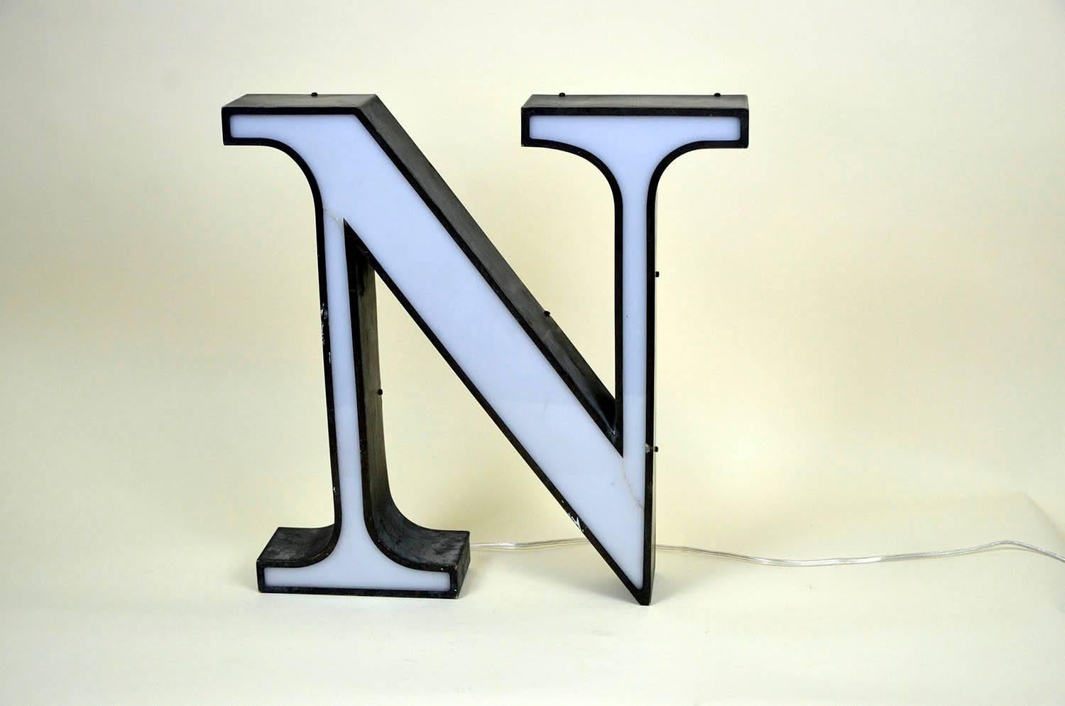 1970s Italian vintage plastic light letter N in white and metal profile now with LED light.

 The sign presents two little restored cracks.