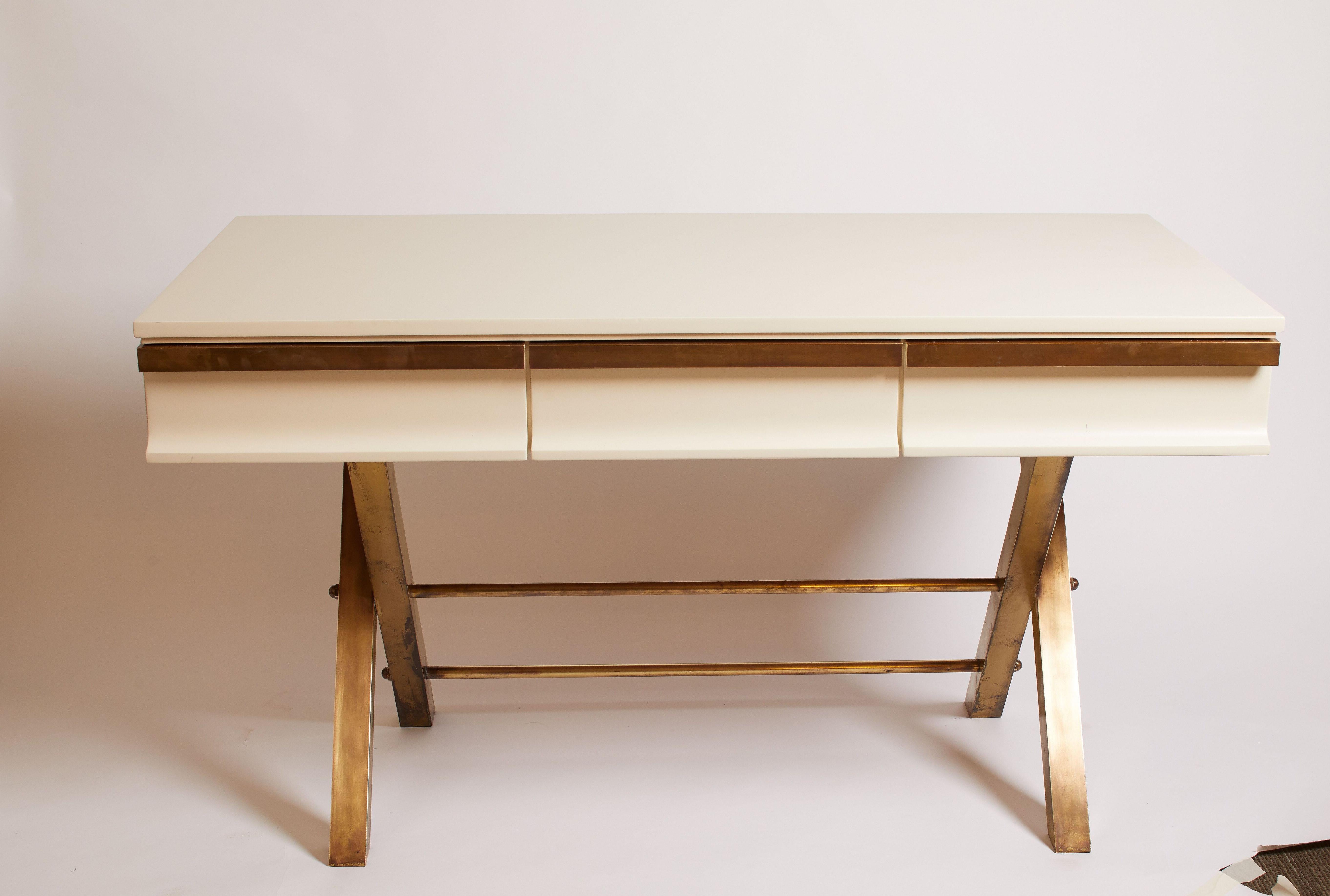 Italian white lacquer desk featuring brass legs and brass details on drawers, circa 1970.
