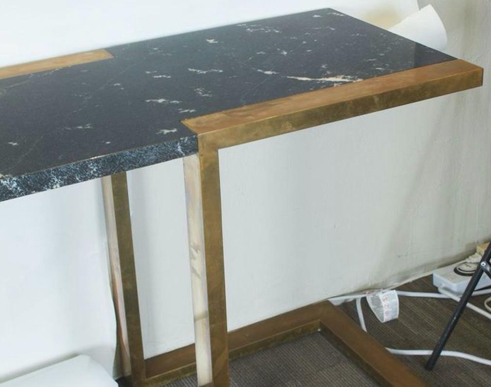 1970s Italian Willy Rizzo dark marble table with brass detailing and legs. Stamped 