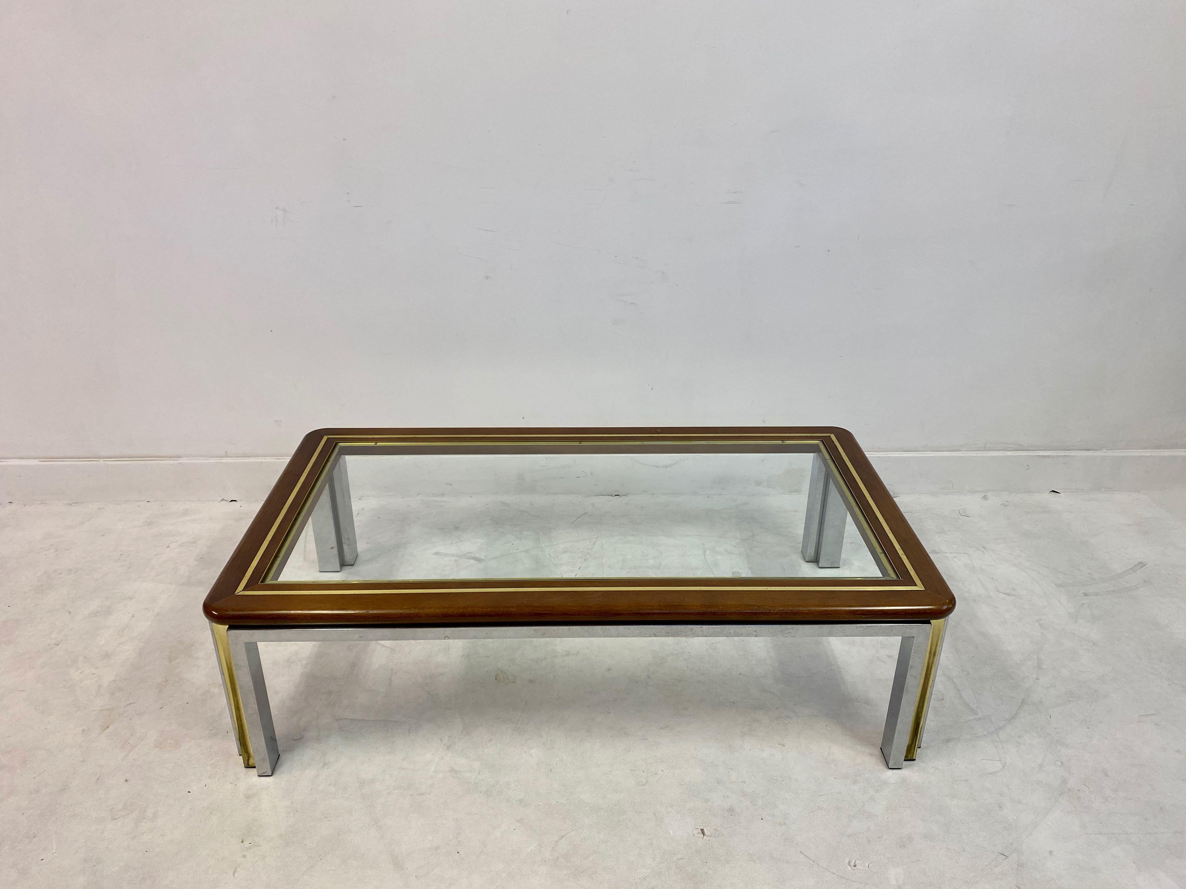 Coffee table

Wooden top with brass banding

Chrome and brass legs

Italy 1970s.