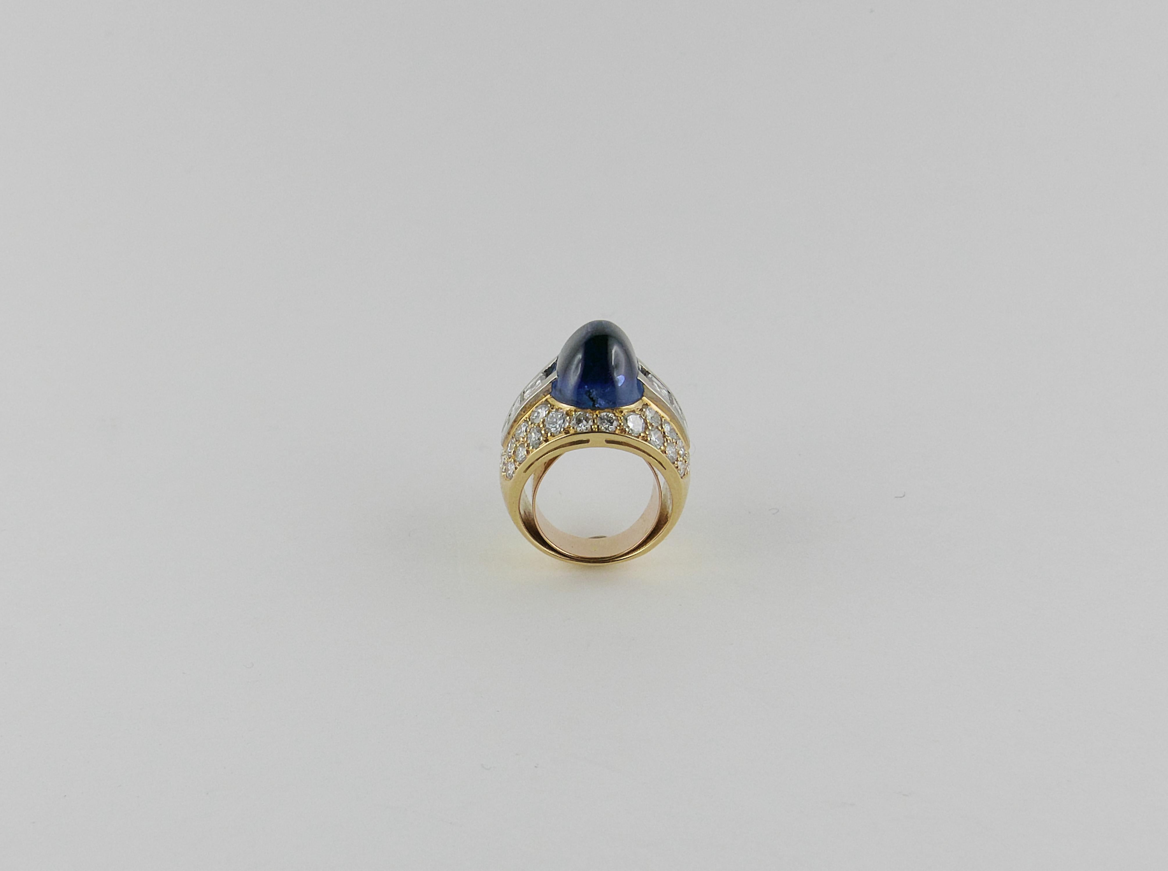 Extremely elegant geometric Ring finely crafted in Italy in 1970s  in rich 18 karat polished Yellow Gold  featuring a splendid central sugar loaf-cut intense blue Ceylon Sapphire no heat of 11.83 cts total weight, enlighted with approx. 2.5 cts. of