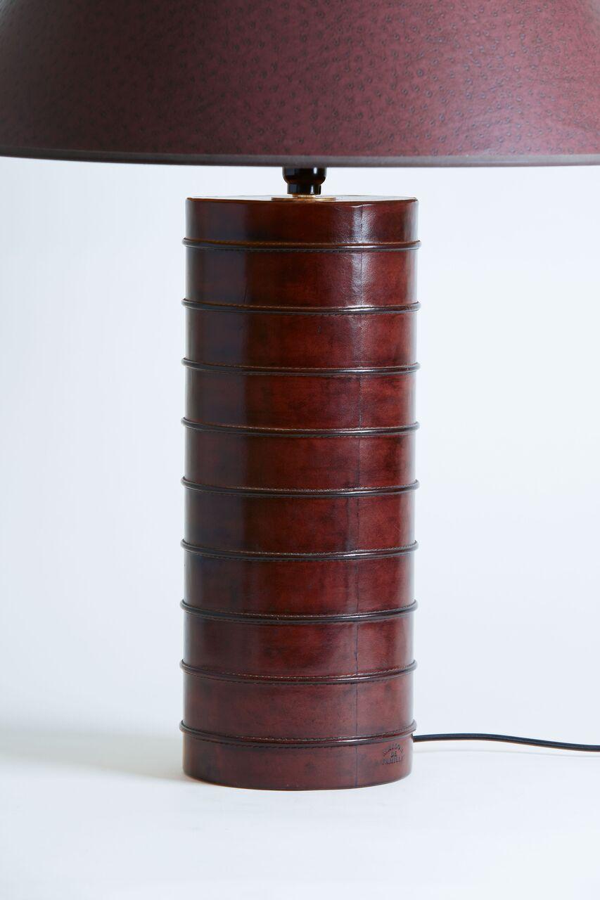 Pair of leather stitched table lamps with original shades in chesnut printed ostrich pattern.
