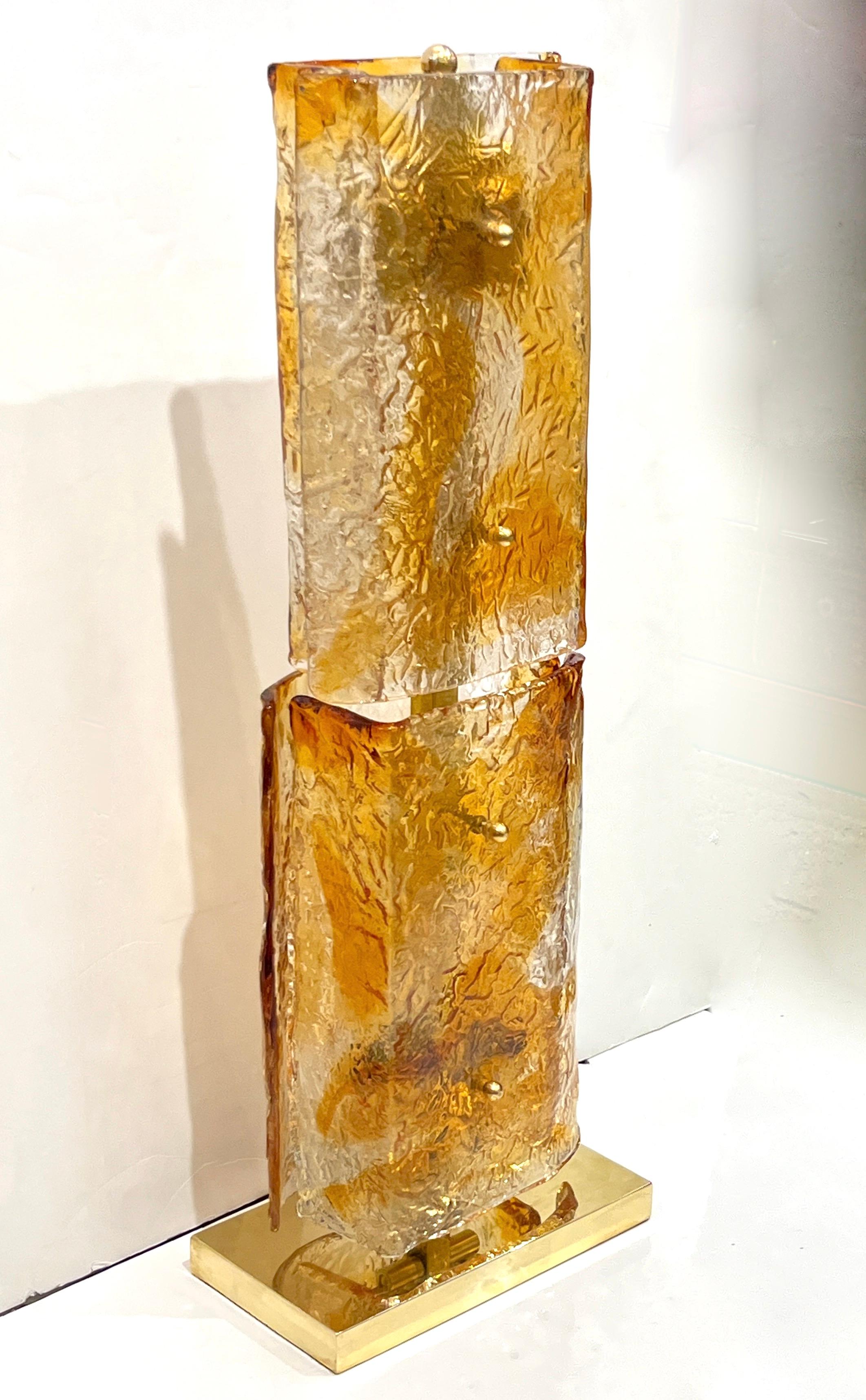 A sculptural and luminous pair of huge mid-20th century organic modern design Murano glass table floor lamps entirely hand made in Italy, in excellent condition, consisting of vintage geometric Art glass elements mounted on new brass upright