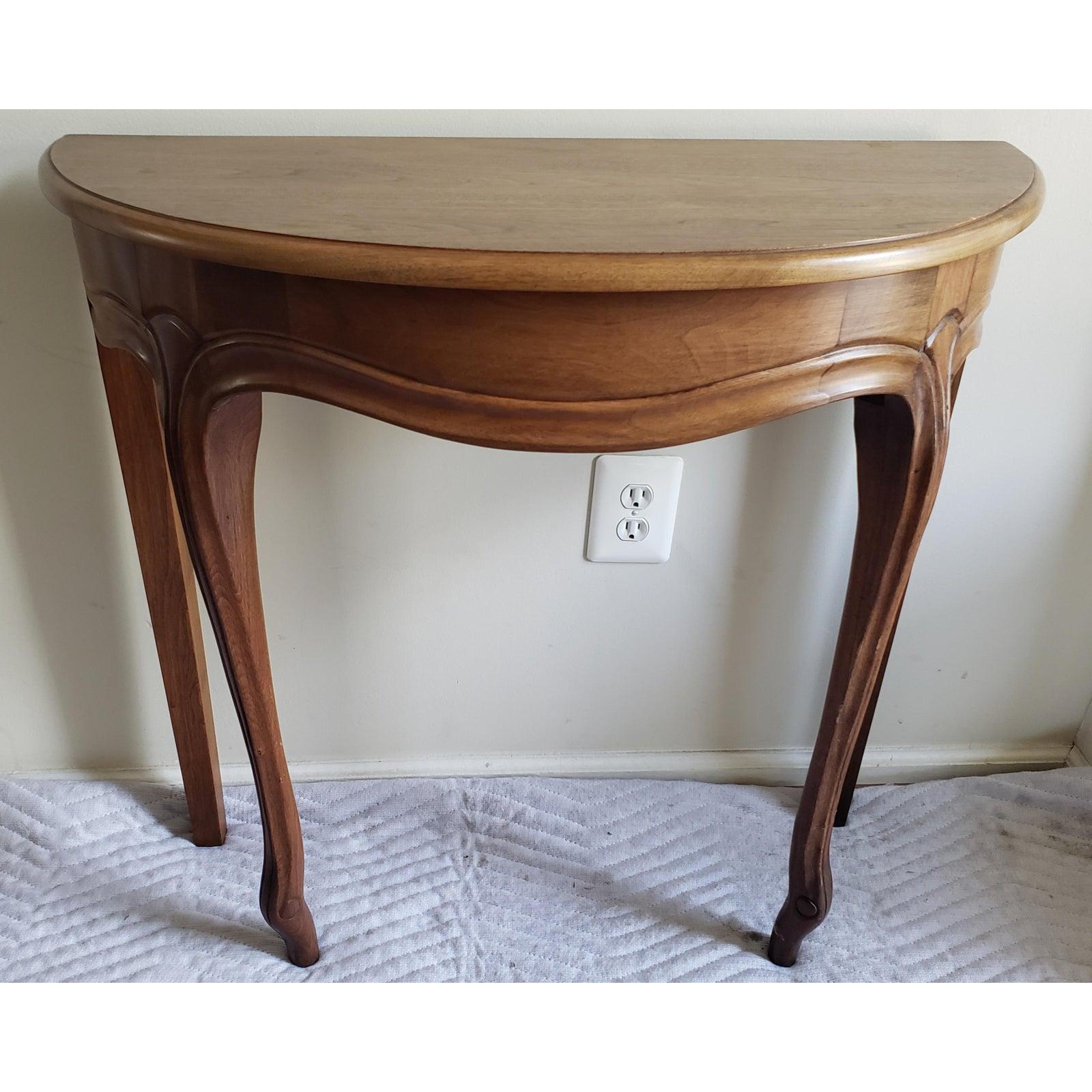 Solid dark walnut wood demilune foyer table with carved legs. Minimal wear. Hand rubbed finish. The maker is J. Raymond Smith Furniture Co. in Shippenburg, PA. Made in 1976. 
measurements are 30.75