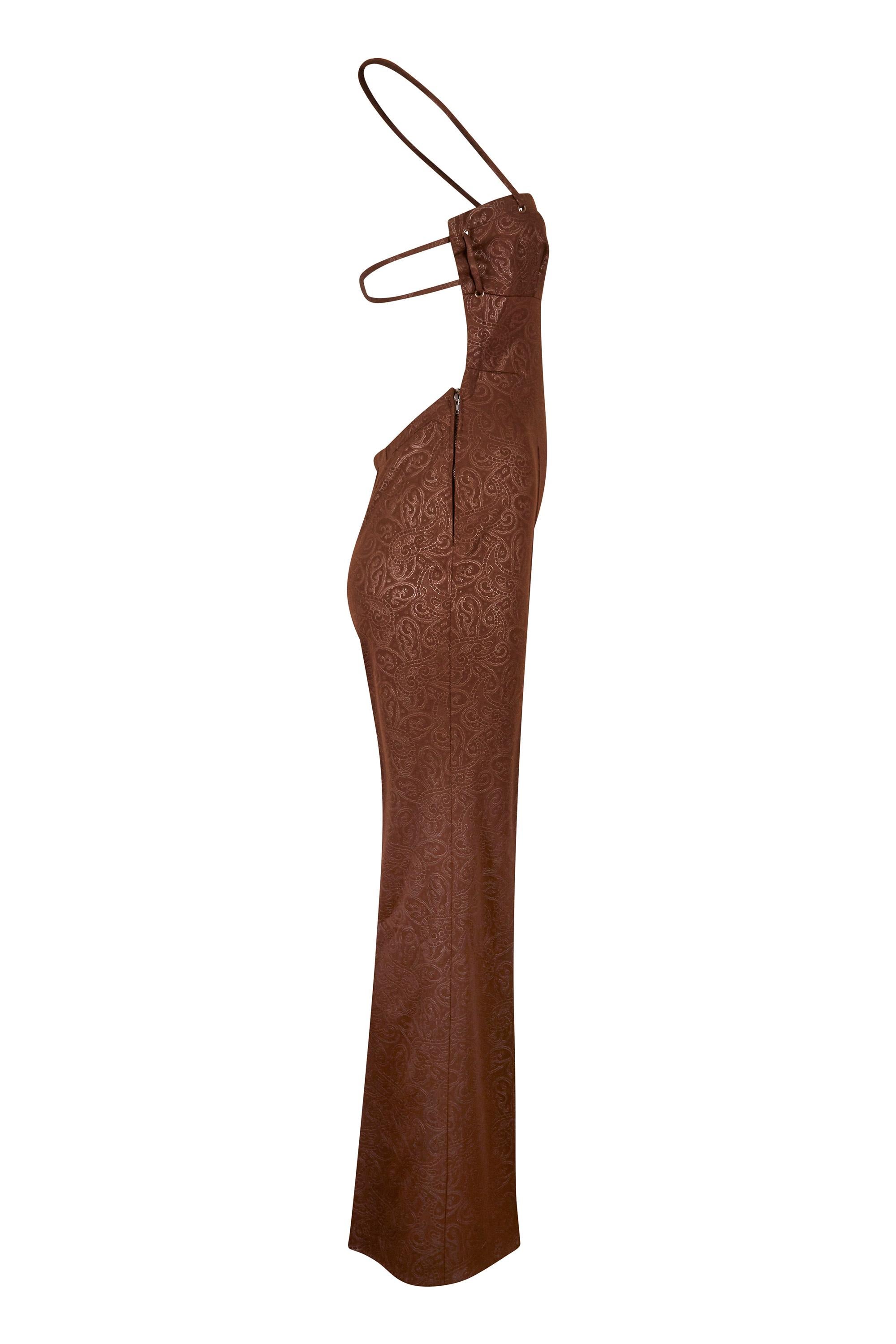 This gorgeous 1970s chocolate brown halter neck jumpsuit with embossed paisley print and flared trouser legs is by French leisure wear designer J.Tiktiner, known for high style beach and play wear for the Cote d’Azur set. This lovely piece is