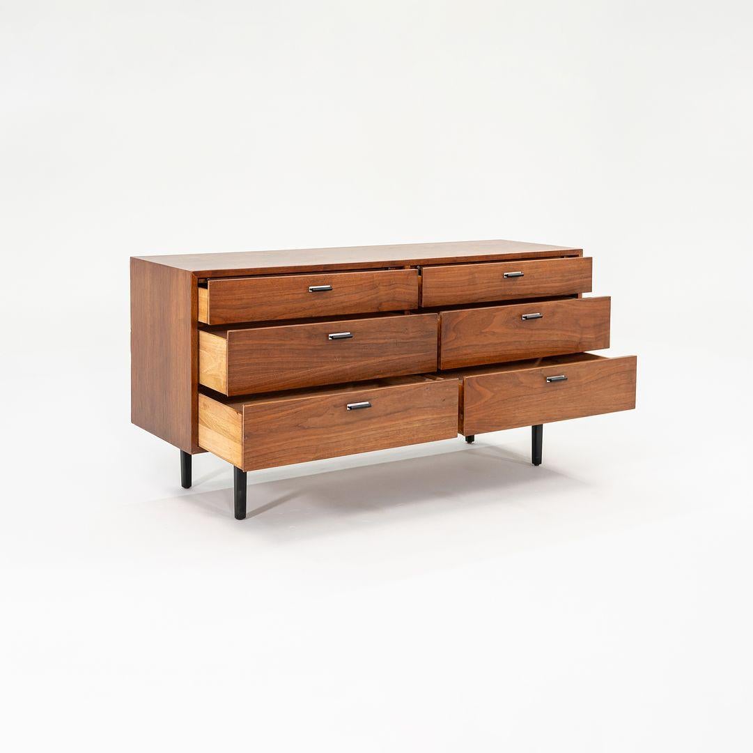 This is a Walnut Six Drawer Credenza Dresser, designed by Jack Cartwright for Founders Furniture in 1970. It has a case of walnut and features six wide drawers that have Dovetail Joints. It features a construction of both solid walnut and walnut