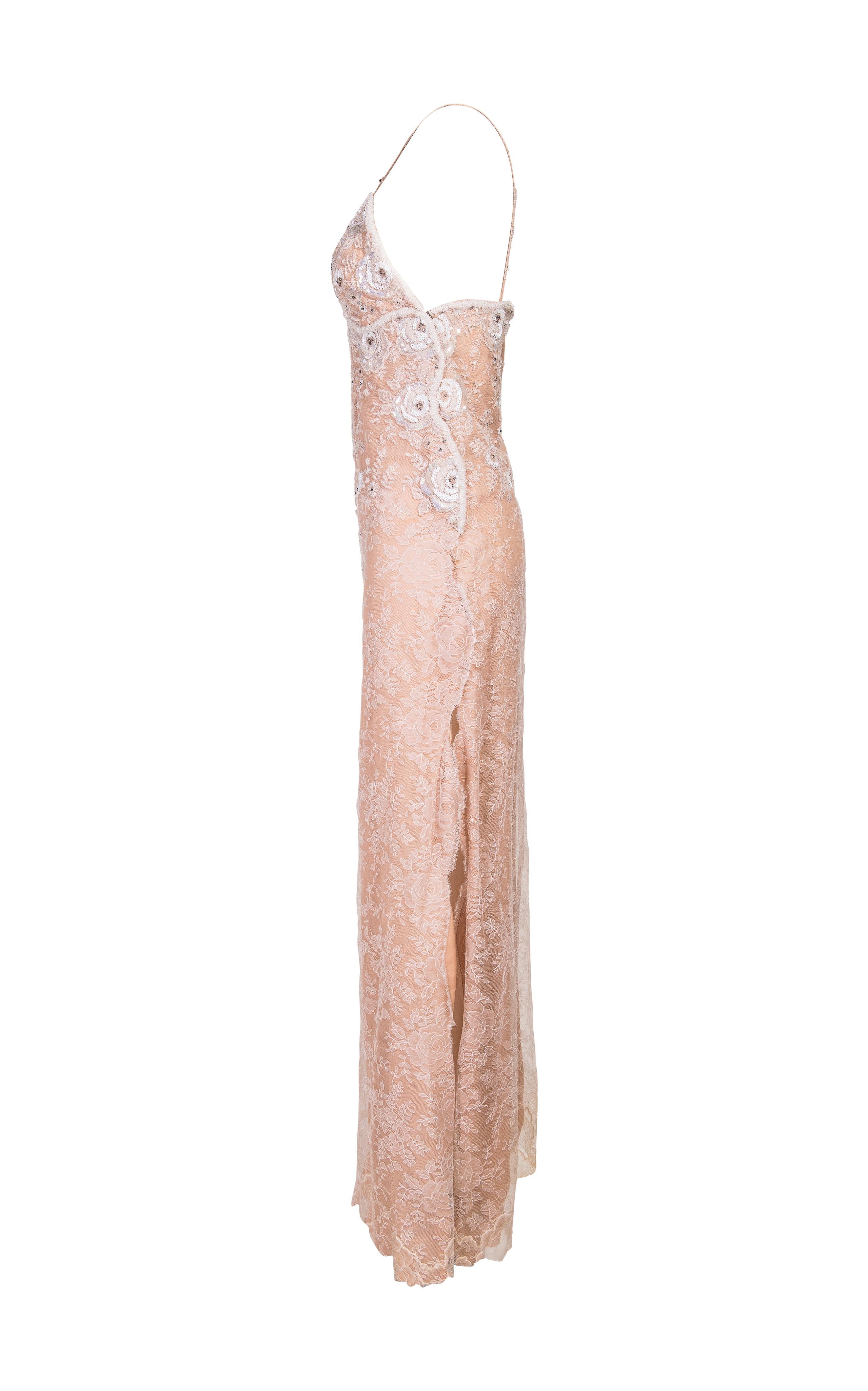 1970's James Galanos lace hand-embellished gown. Peach gown with white lace overlay and hand-embellished sequin and beaded floral details. Zig-zag snap button closures on side add special detail.
