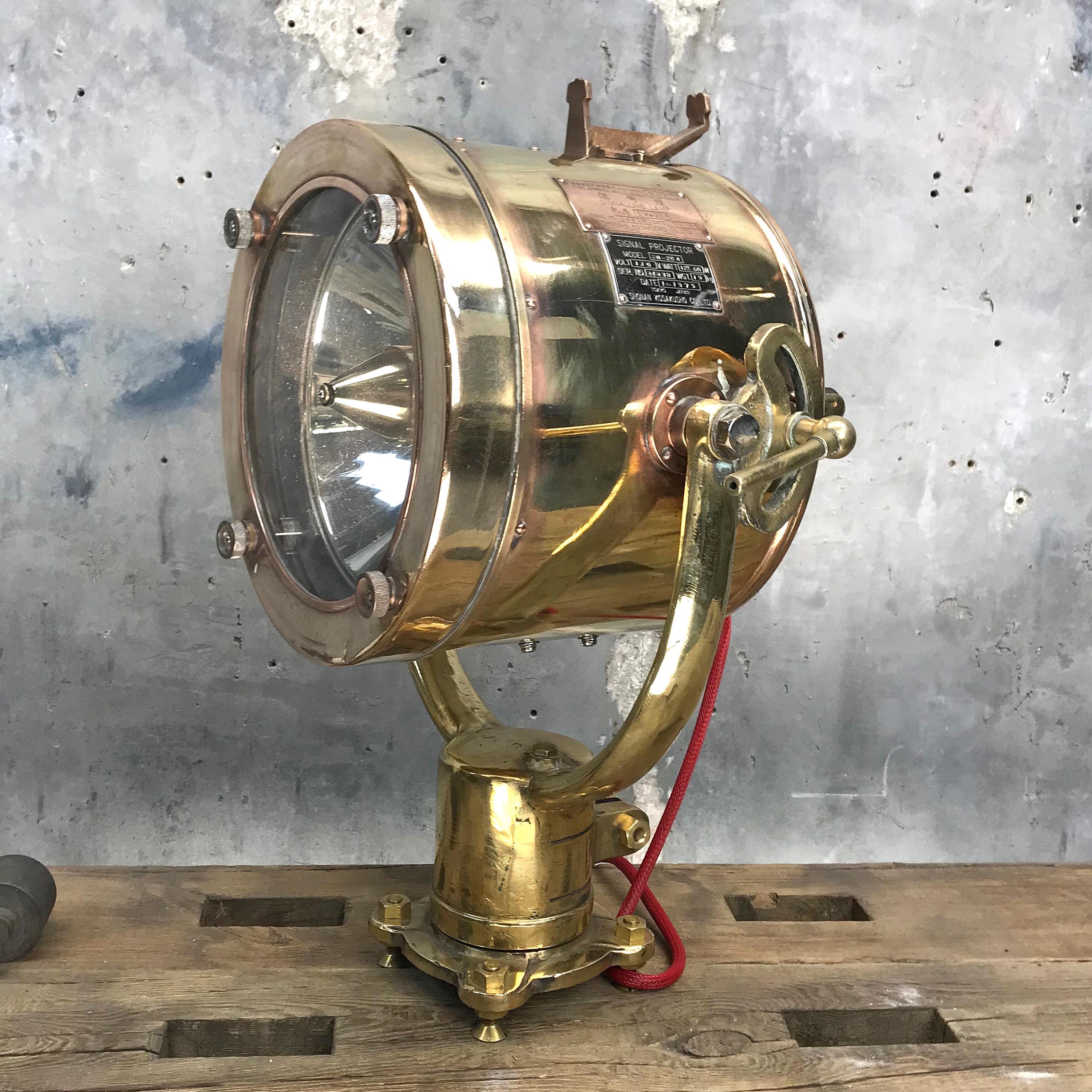 This is a Shonan Kosakusho signalling / projector lamp made in 1979 in Tokyo, made from sold brass and tempered glass.

Reclaimed from Mid-Century war ships, Shonan did manufacture these during World War 2 until the firestorm on Japan ceased