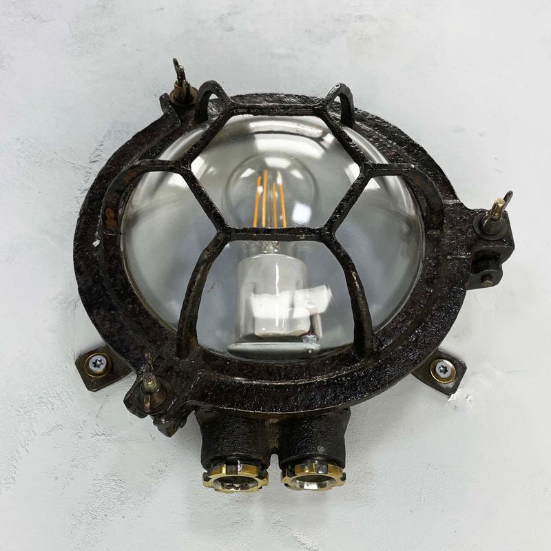 Vintage industrial cast iron circular bulkhead wall lighting with a hexagonal target cage and clear glass dome. Perfect robust and rustic light fixtures.

Reclaimed fixtures originally used on cargo ships and supertankers to illuminate