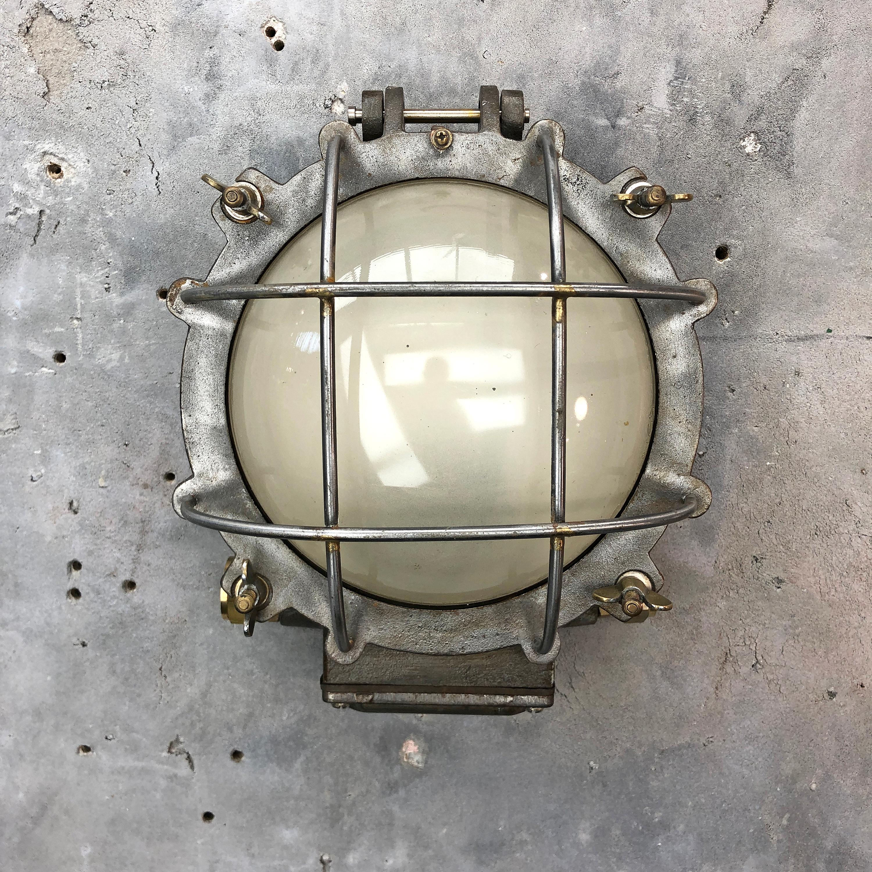 A solid cast iron reclaimed industrial wall / bulkhead lamp.

This substantial wall light has been stripped of paint back to its raw finish and lacquered to protect from rust.

The electrics have been replaced and are factory tested for