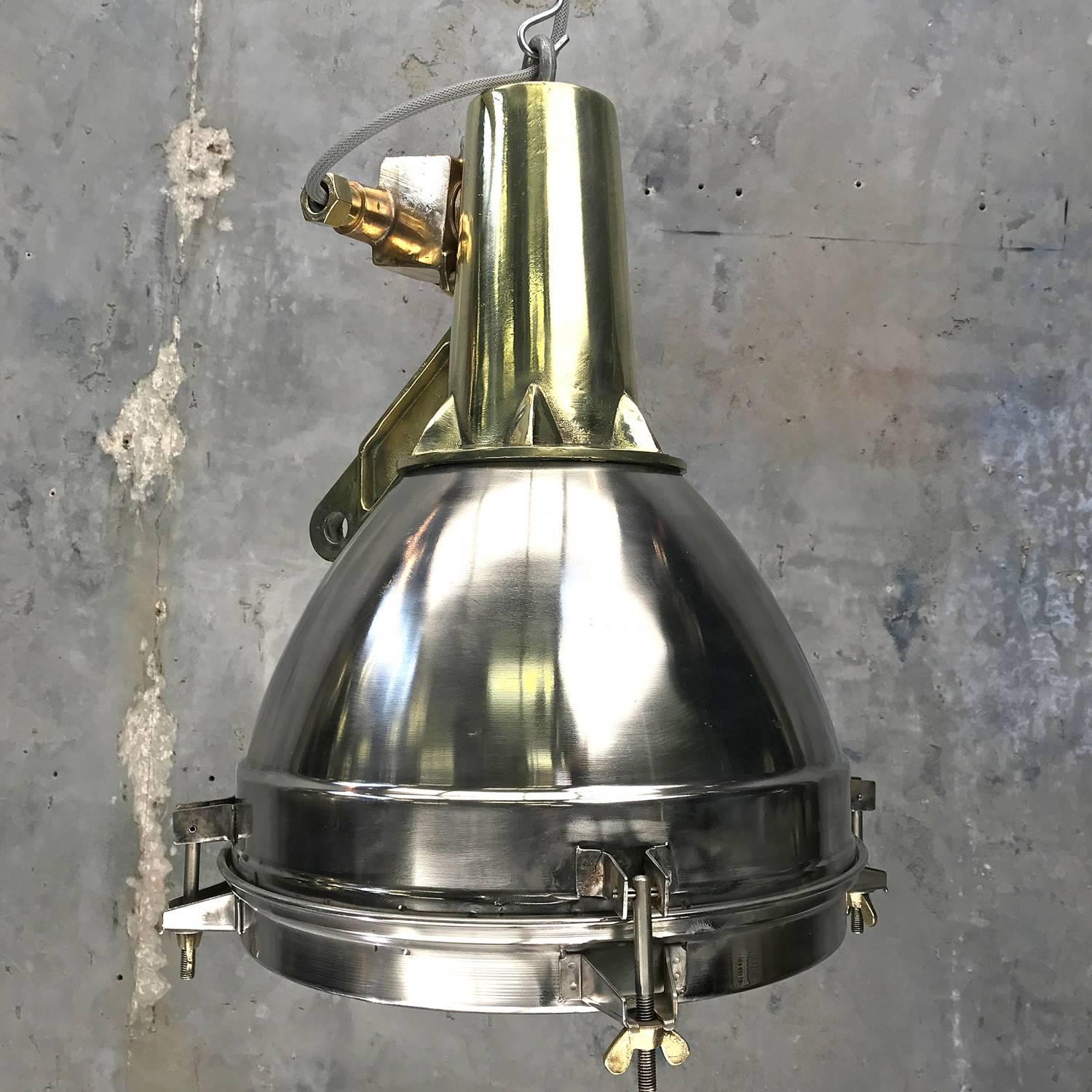 Original stainless steel, cast brass and bronze search light pendant conversion

This very substantial fitting was salvaged from an old Japanese cargo ship, built during the 1970s and is of outstanding build quality.
The stainless dome is spun with