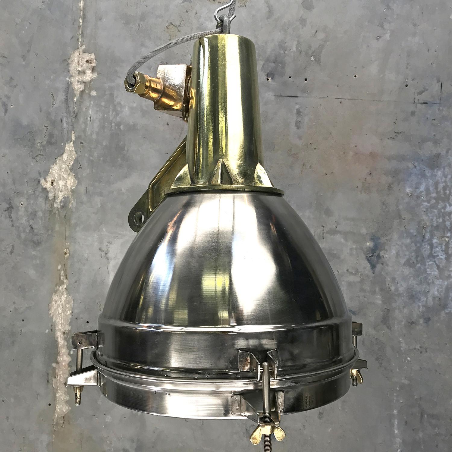 Original stainless steel, cast brass and bronze search light pendant conversion.
 
This very substantial fitting was salvaged from an old Japanese cargo ship, built during the 1970s and is of outstanding build quality.
 
The stainless dome is