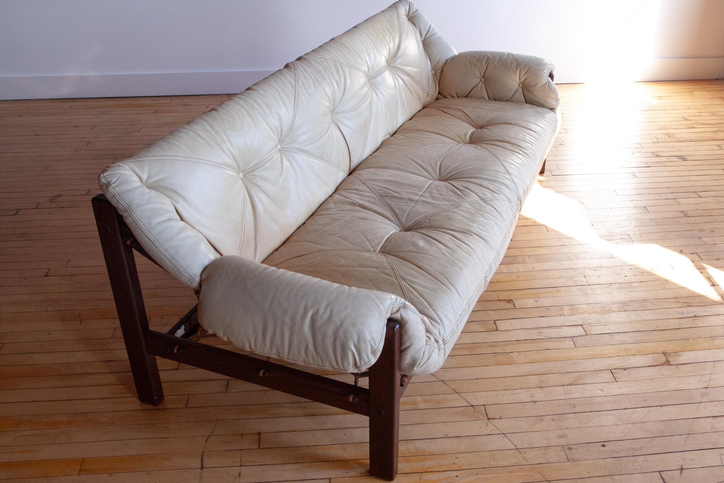 Designed by Jean Gillion for Italma of Brazil in the 1970s, this 'Tijuca'' sofa features a thick ivory leather cushion supported by an intricately woven string hammock on a solid Brazilian Rosewood Frame.

Very comfortable. 


This sofa is