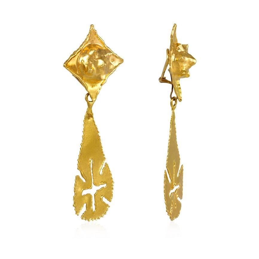 A pair of estate hand made gold day-to-night earrings, the diamond-shaped tops with domed centers suspending removable teardrop-shaped pendants featuring incised designs, in 22k.  Jean Mahie