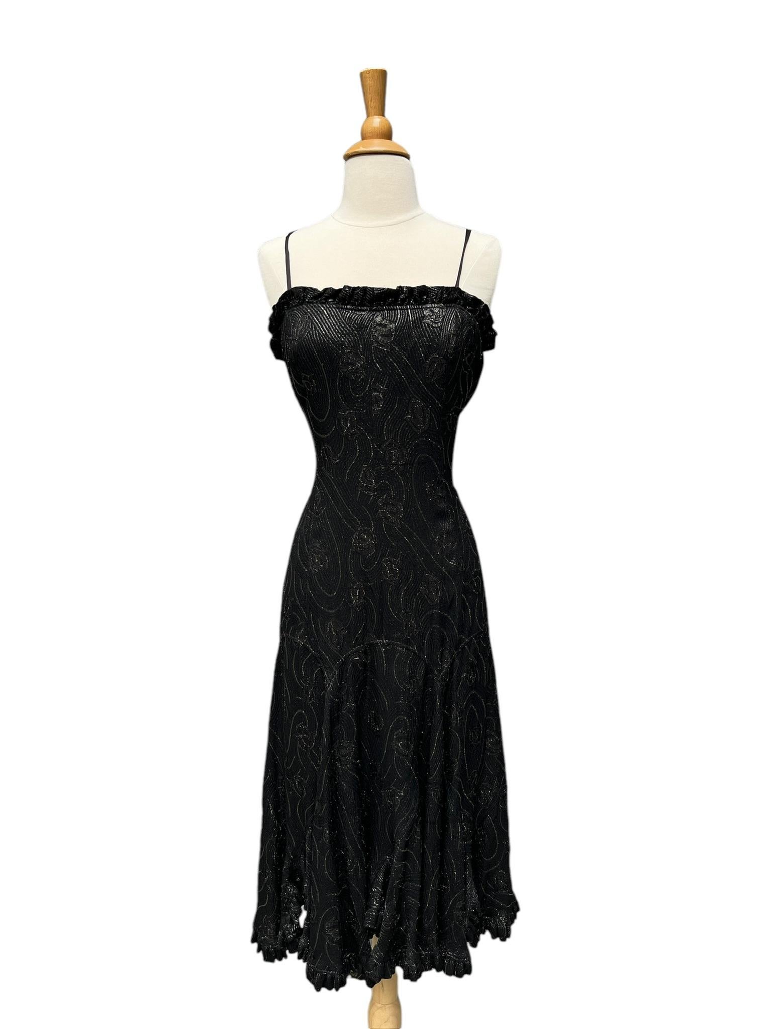 Vintage Jean Varon metallic dress.

This dress is a beautiful dark raisin or licorice (brownish black) with bronze lurex thread throughout. Swirl and floral pattern. Straight silhouette with flouncy ruffled hem. The bodice has an interior built in