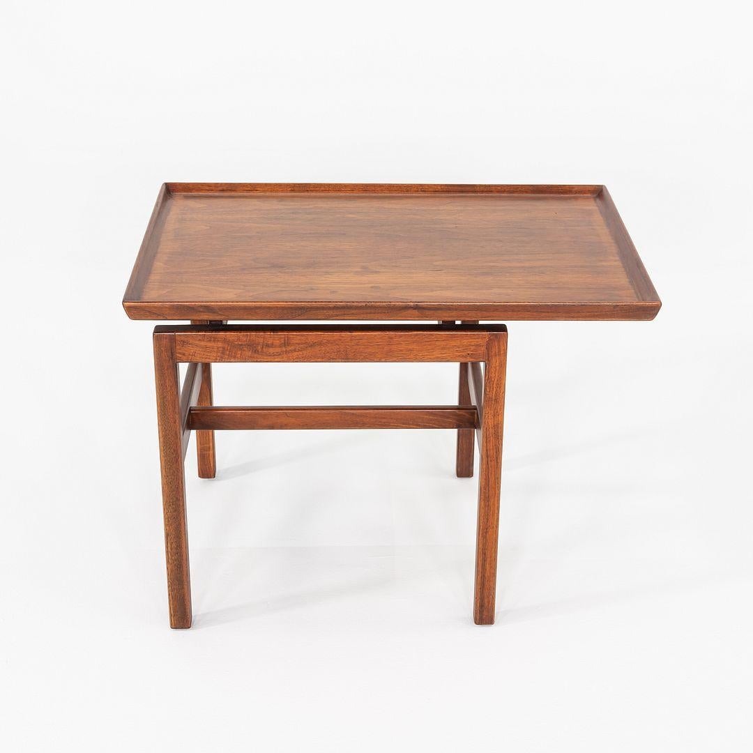 This is a Walnut Side Table, originally designed by Jens Risom for Jens Risom Designs. This particular example was handcrafted in the United States and dates back to the 1970s. 

The table measures 21.25 inches deep, 30.25 inches wide, and 22.25