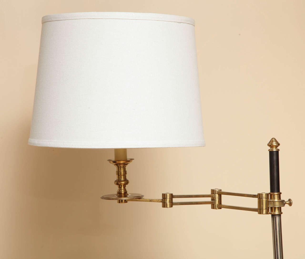 A bronze and steel standing lamp with accordion fold arm of adjustable height resting on a stepped square bronze and steel base. Manufactured by Jerome Sutter, circa 1970s.
