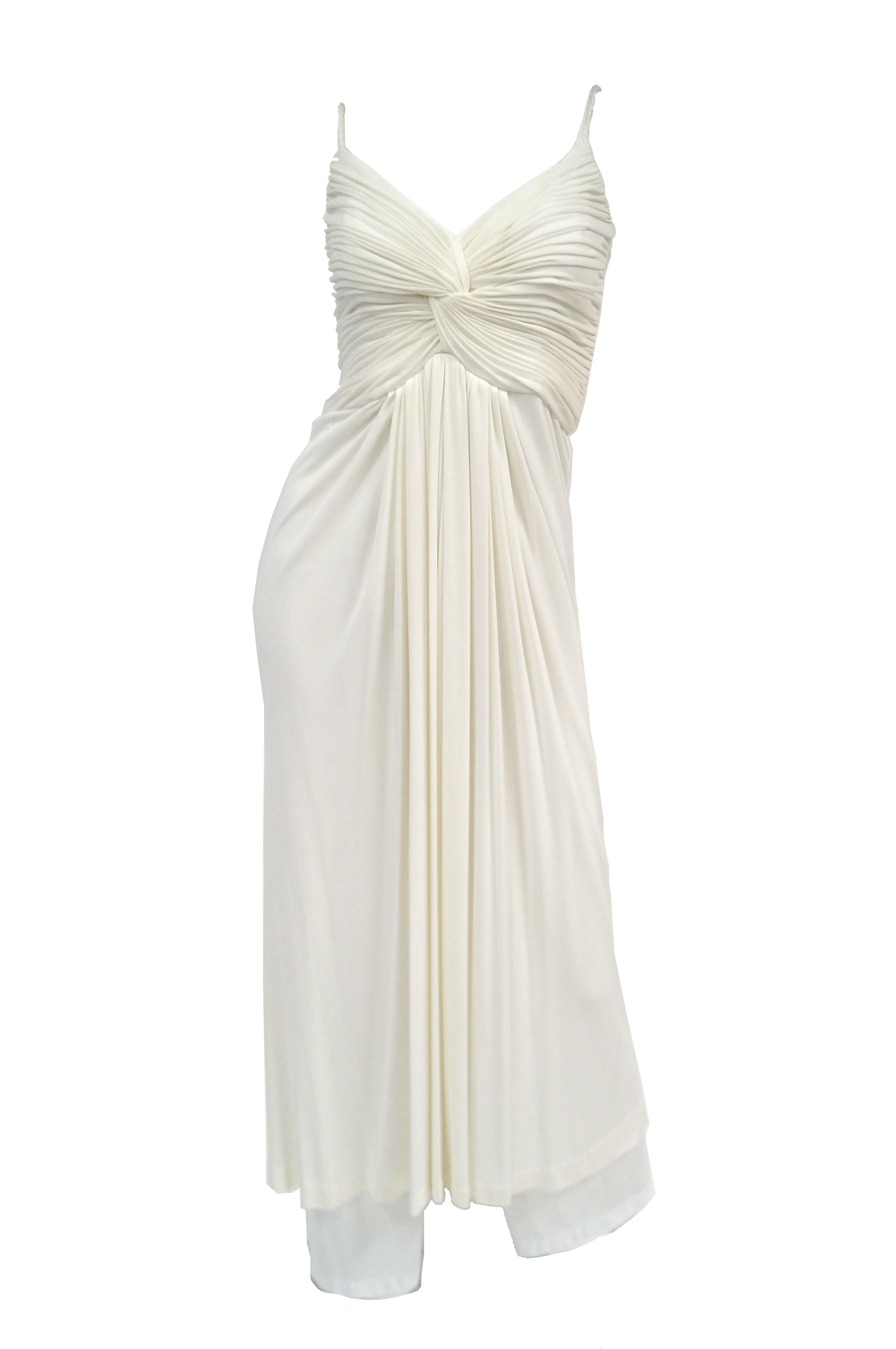 Channel your inner Marilyn or dance like studio 54 could only have imagined in this fun and flirty knit white dress by Jill Richards. The dress ensemble is composed of a white maxi dress and coordinating white knit shawl. The dress has a sweetheart
