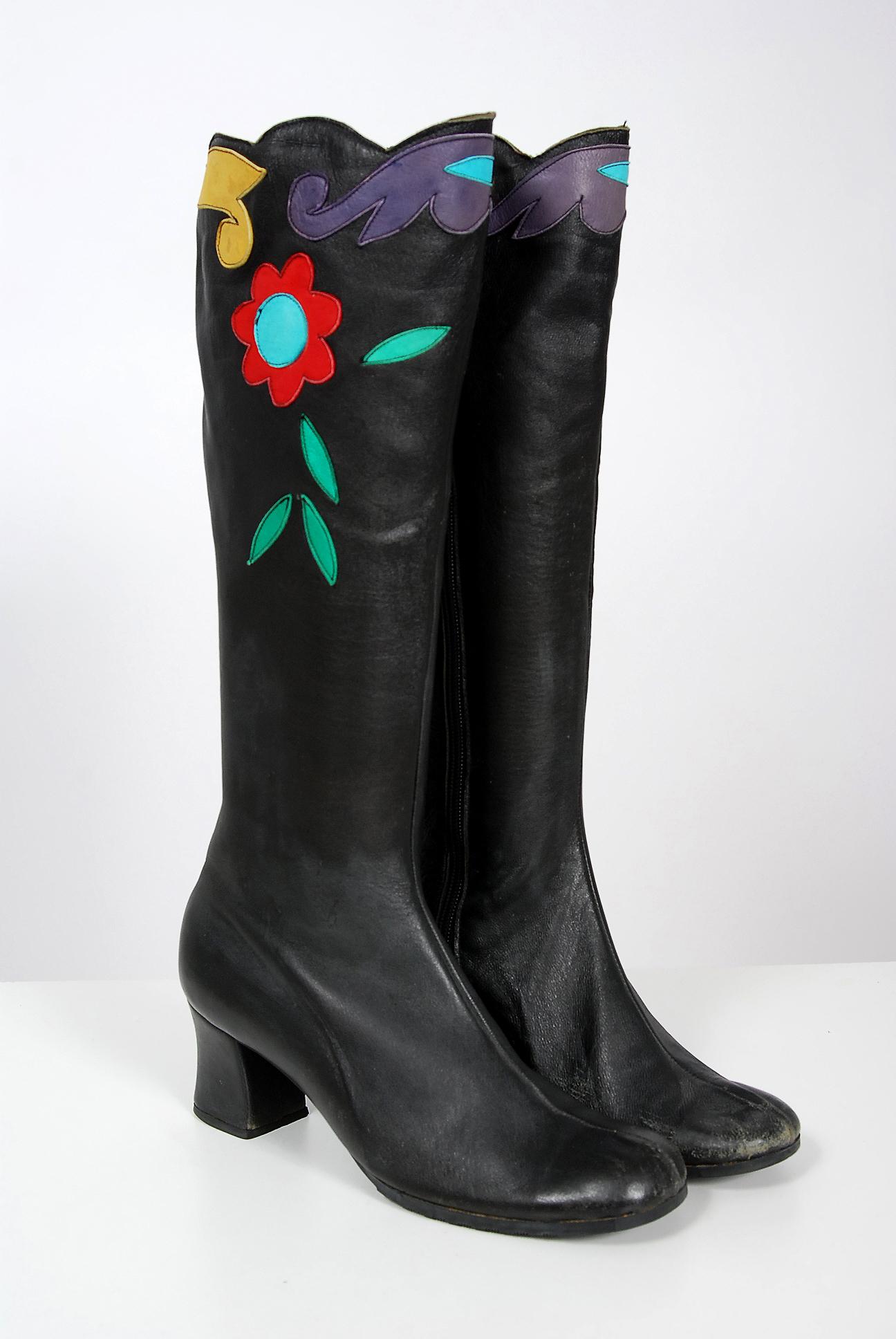 Amazing early 1970's Karina of Spain designer black leather boots with the most incredible floral swirl applique work! These boots have a unique scalloped edging which works so well with the vibe. I love the shaped heel and seductive knee-high