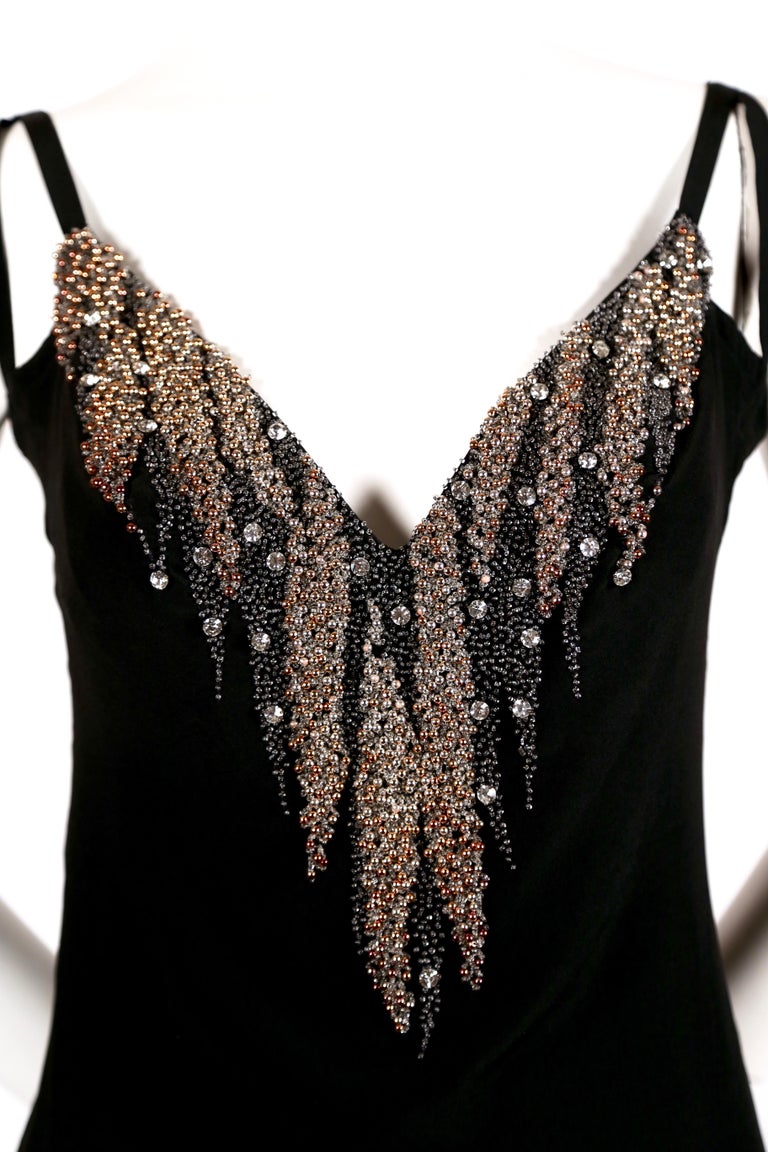 Intricately beaded black silk dress designed by Karl Lagerfeld for Chloe dating to the 1970''s. Dress fits a size 4 or 6. Approximate measurements: bust 34