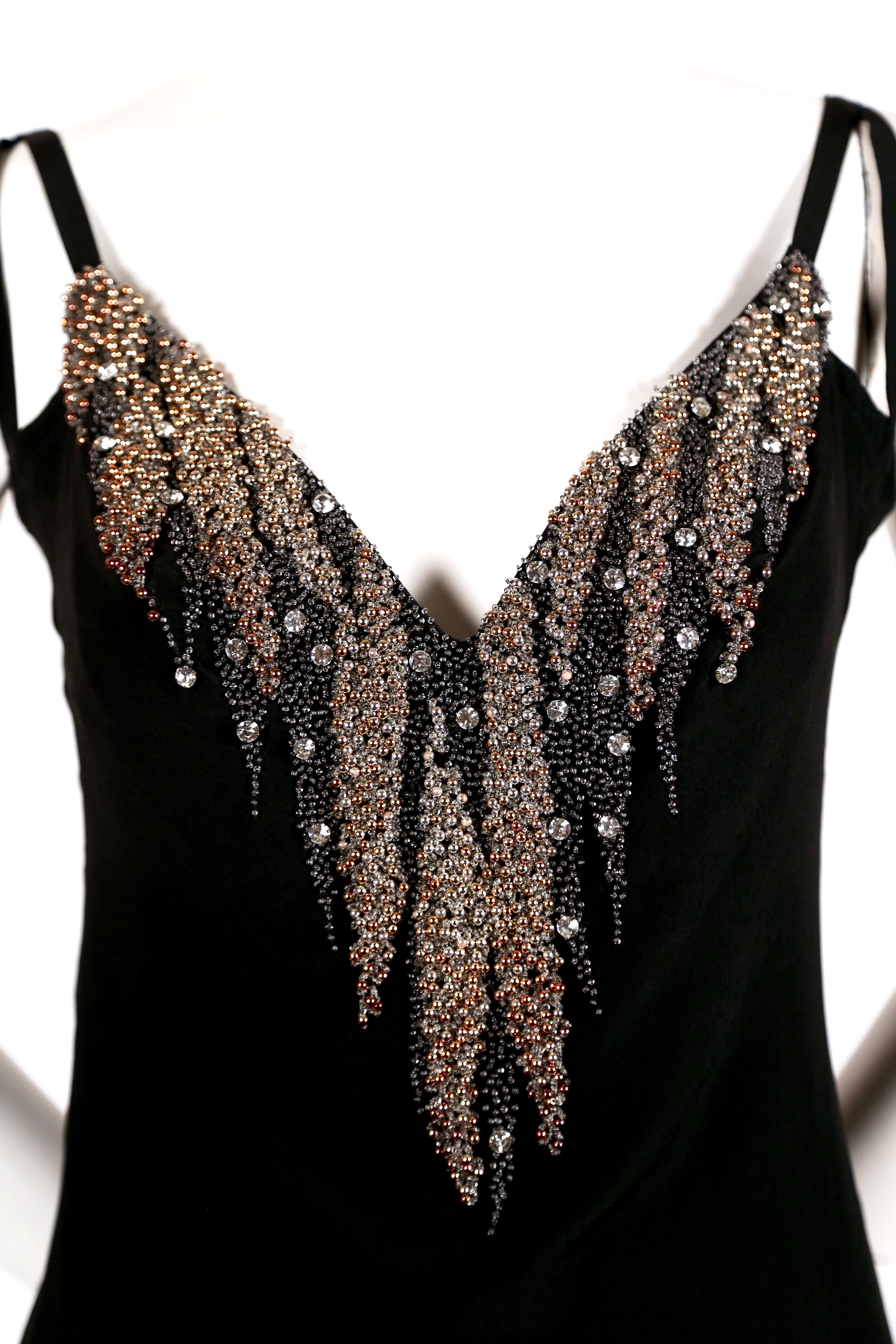 Intricately beaded black silk dress designed by Karl Lagerfeld for Chloe dating to the 1970's. Dress fits a size 4 or 6. Approximate measurements: bust 34