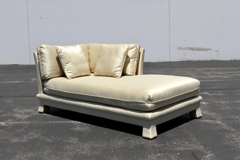 Sleek 1970s Hollywood Regency fully upholstered chaise lounge or sofa for Berhardt Flair in the style of Karl Springer or Steve Chase in original tan silk blend upholstery. Great 70s styling with upholstered flared legs, Ogee around base and angled