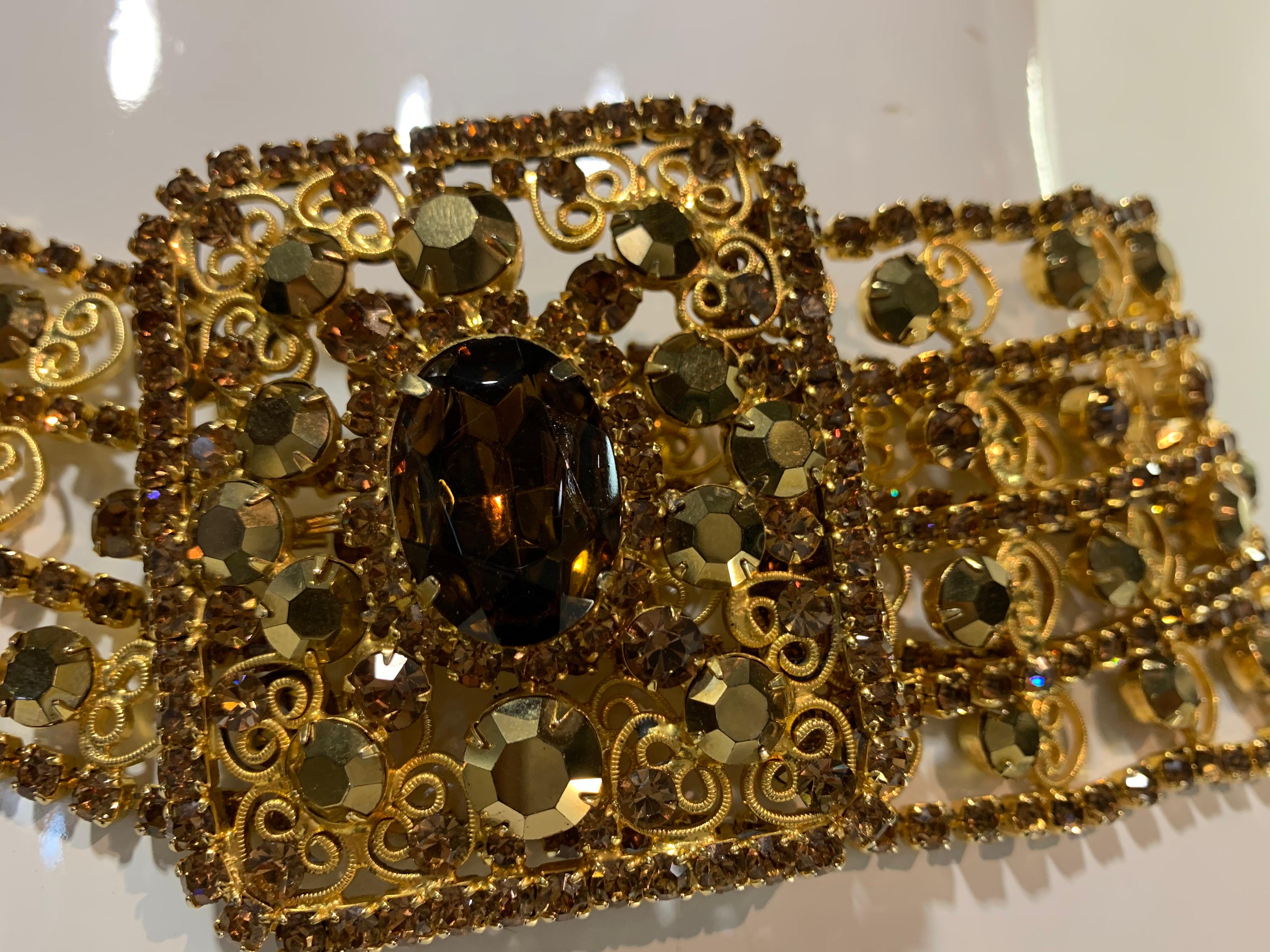 A fabulous and glamorous 1970s wide Kenneth Jay Lane topaz rhinestone and gold filigree evening belt with square buckle and huge rhinestone centerpiece. Adjustable to 30