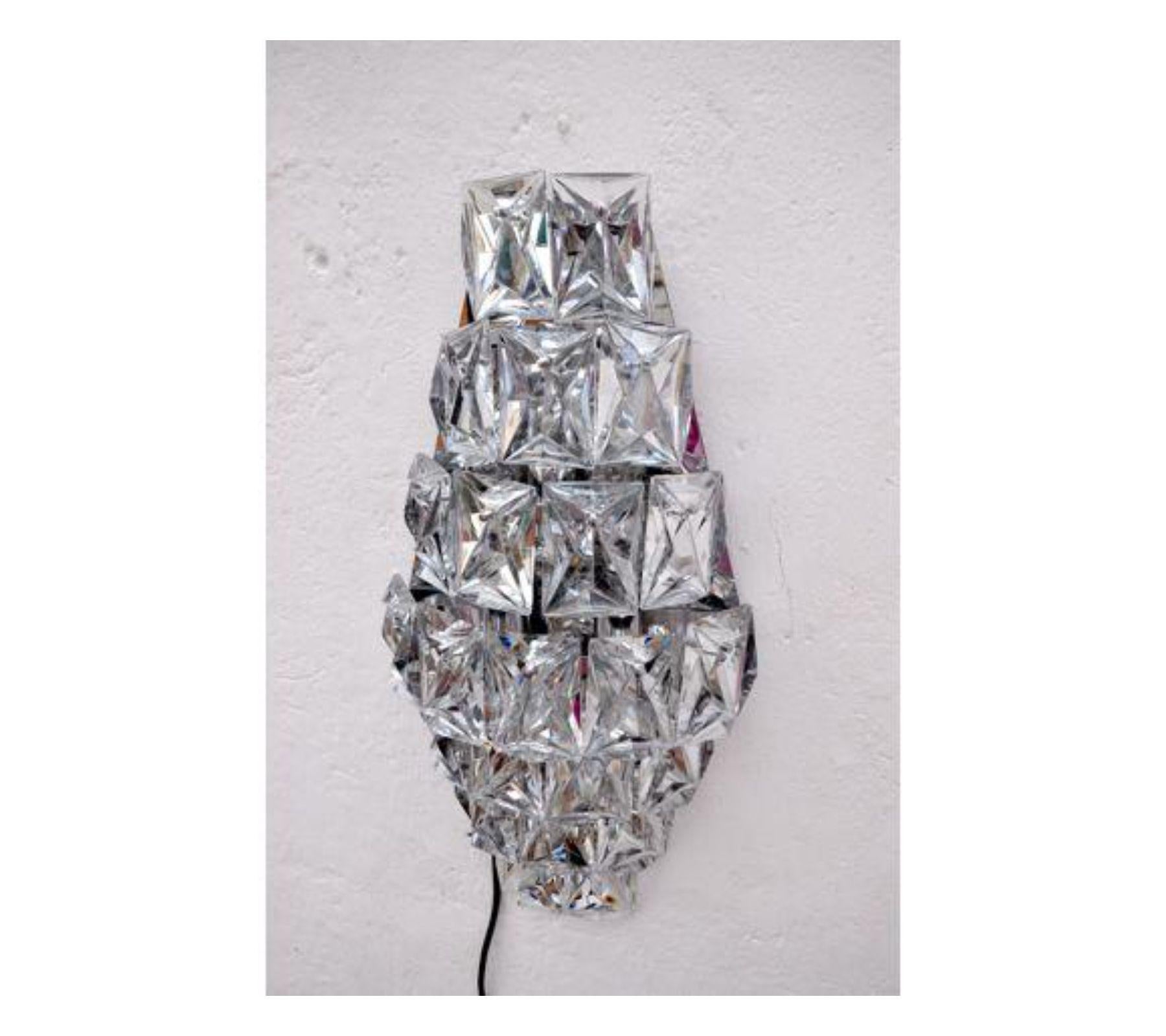 Impressive kinkeldey wall sconce designed and produced in Germany circa 1970s. Metallic silver platted Structure with 7 levels and 23 crystals. A unique piece of design that will be great highlight in your interior project. Object in mint