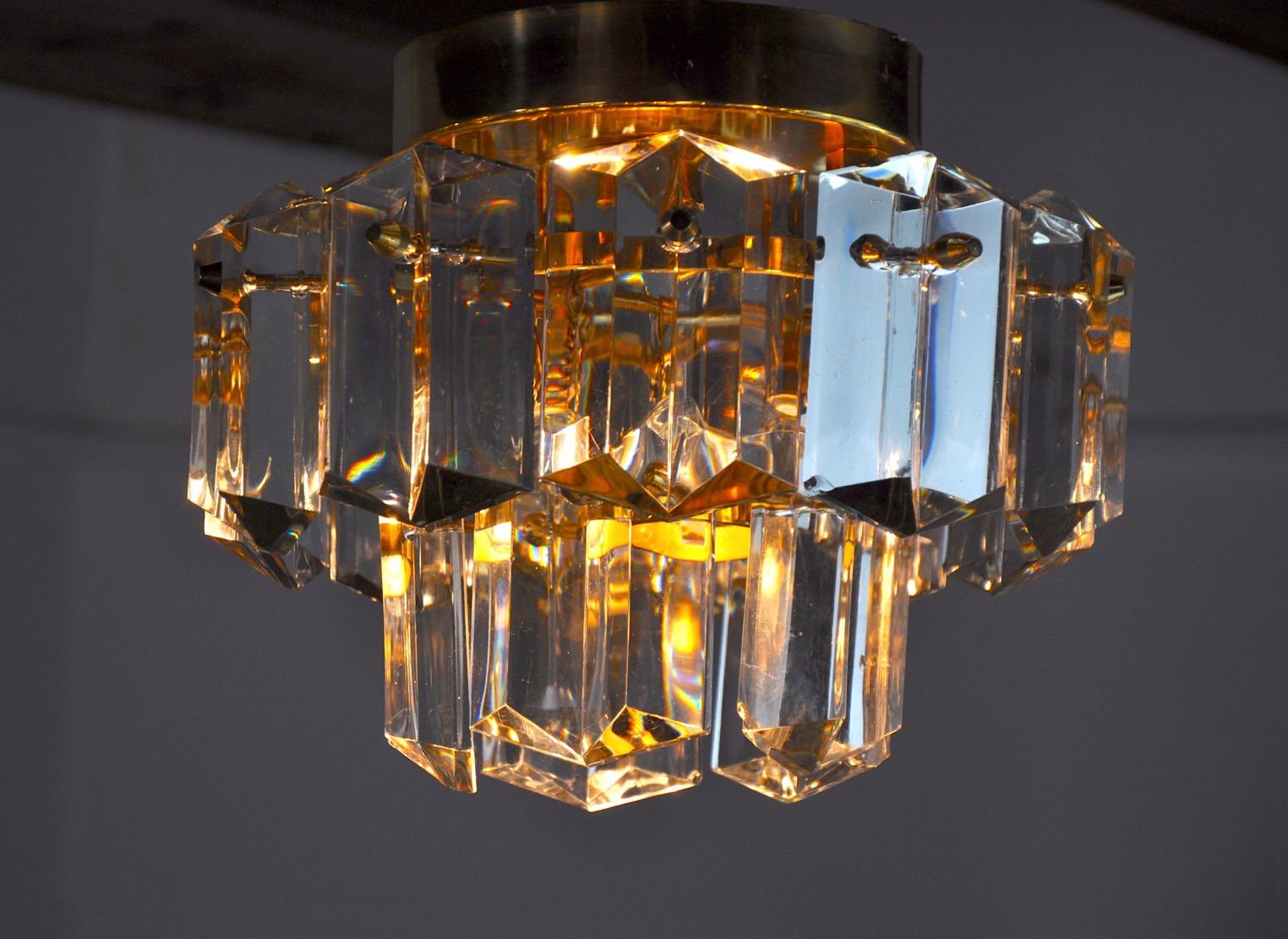 Rare and superb kinkeldey ceiling lamp designated and produced in germany in the 70s. Golden brass structure composed of cut crystals spread over 2 levels. Rare design object that will illuminate your interior wonderfully. Electricity verified, time
