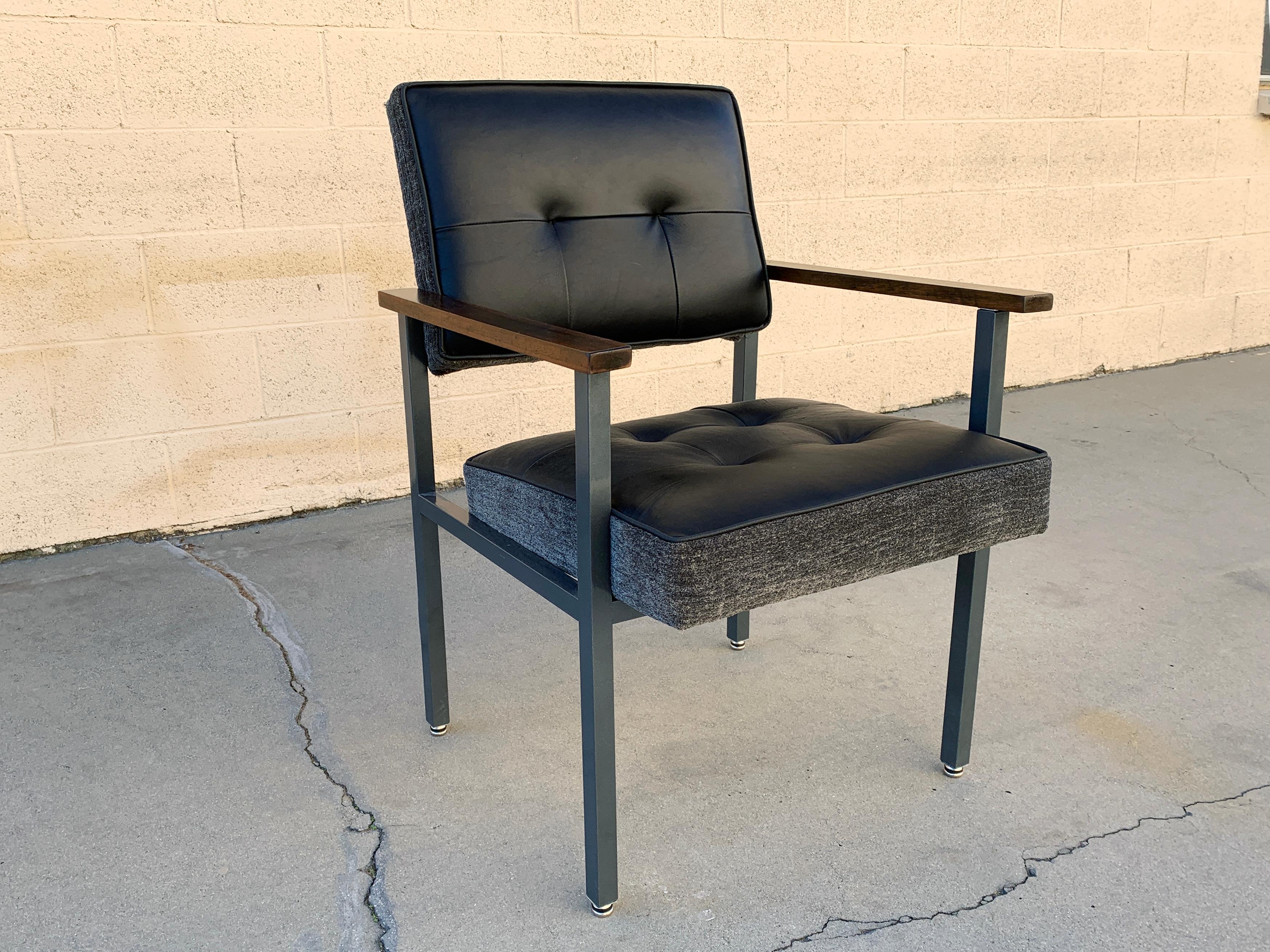 Sleek 1970s armchair in the style of Knoll or General Fireproofing Co. Composed of a steel frame refinished in Metallic Gray (GR02), and new upholstery in two-tone black leather and heather grey chenille. Reconditioned walnut armcaps. In excellent