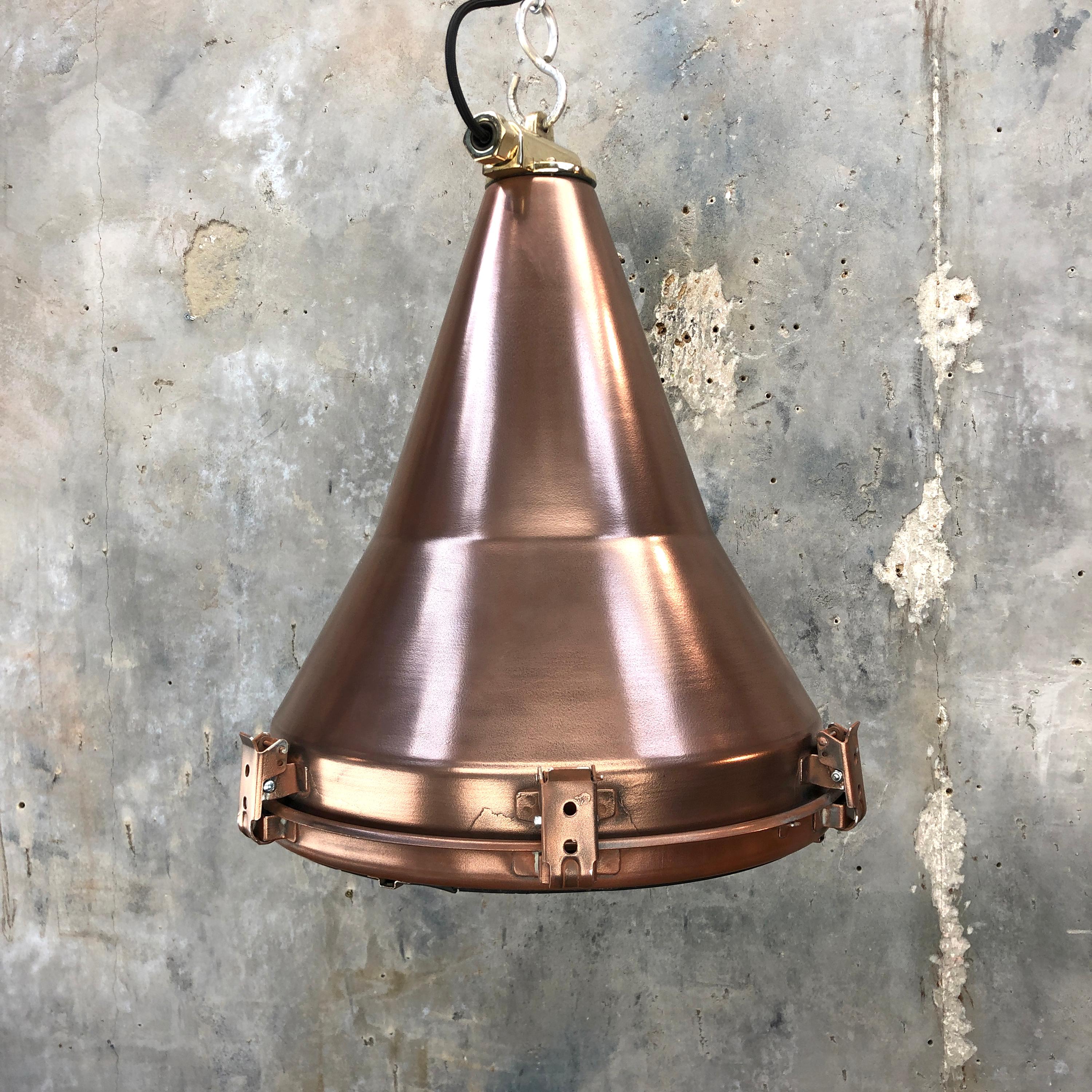 A retro industrial copper ceiling pendant.
 
A reclaimed Korean light fixture reclaimed from decommissioned cargo ships, circa 1970. 

Originally used on masts and gantries to flood light the container deck.
 
Specifications
Measures: