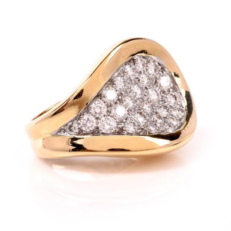 A 1970's ring designed by Kuchinsky crafted in 18 Karat yellow gold, weighing 21.0 grams and measuring 20 mm wide and 6mm high. In an avant-garde style, the ring depicts a diamond-swathed teardrop shape profile, simulating a snake head adorned with