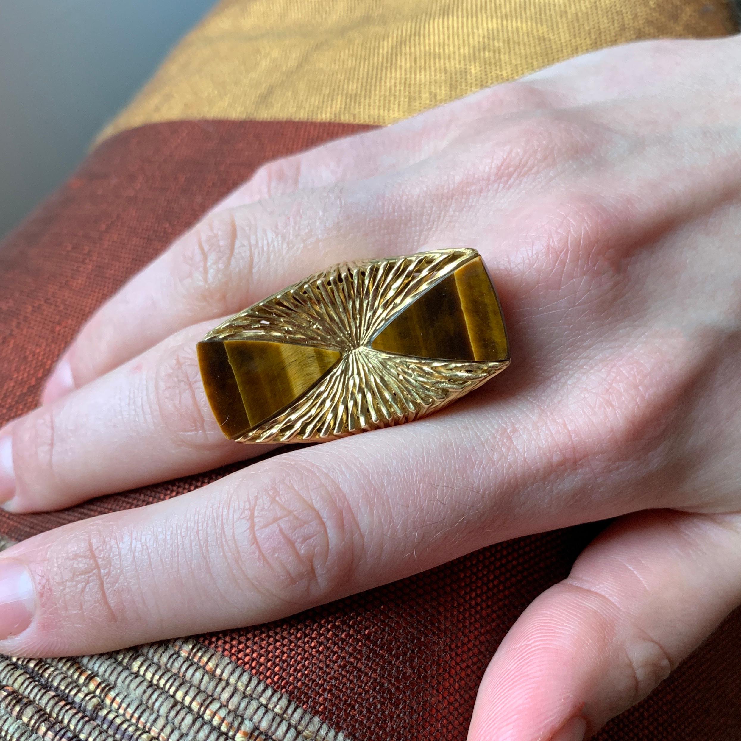 An 18 karat gold and Tiger's Eye ring, by the London jeweler Kutchinsky, c. 1970. 

The ring measures a size 7. It is signed Kutchinsky, makers mark K LD,  London Hallmarks dated with the letter 