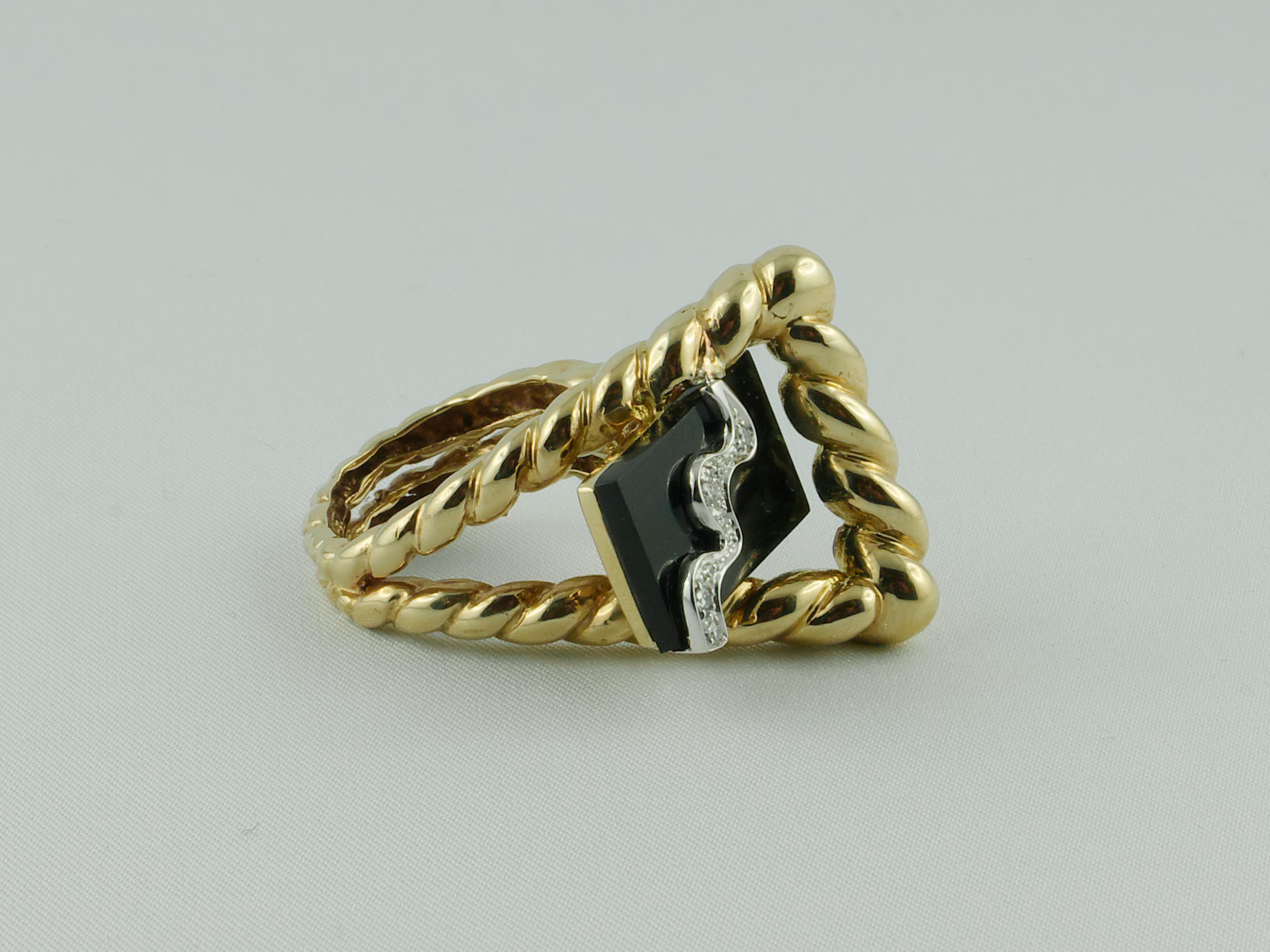 Attractive, unconventional and asymmetrical 1970s La Triomphe Onyx Gold and Diamond ring.     A Diamond wave motif adorns and enlights the top running through the Onyx element.  The shank has a slightly graduating fluted swirl design. The Onyx 