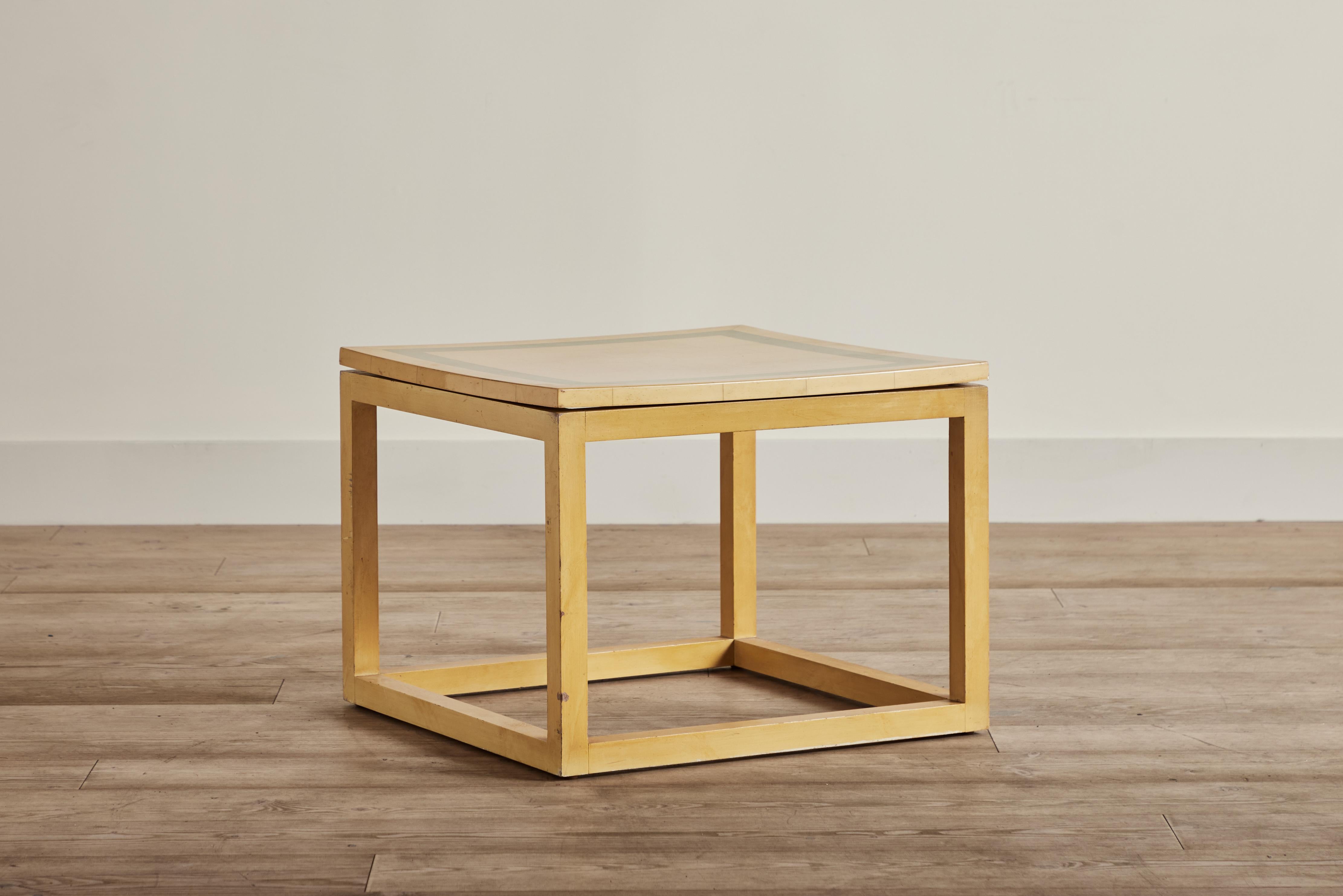 Yellow and green lacquer side table from France circa 1970. Visible wear throughout on lacquer finish. Top is warped at the edges. Two matching side tables received. Each sold separately. 