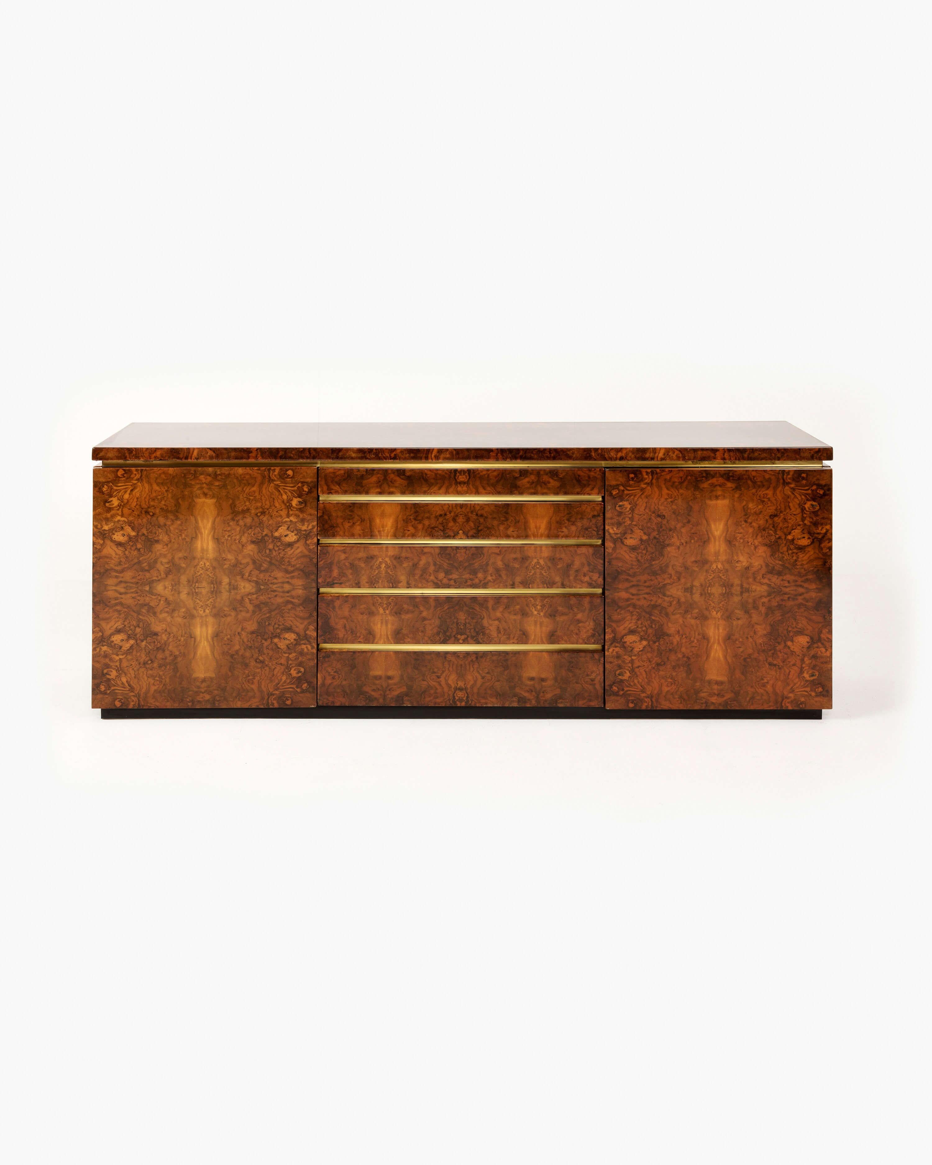 This lacquered burl sideboard by french designer Jean-Claude Mahey boasts a distinguished gilded profile that reflects the designer's affinity for the finest materials. Born in the northwestern French city of Mayenne—a region populated by small