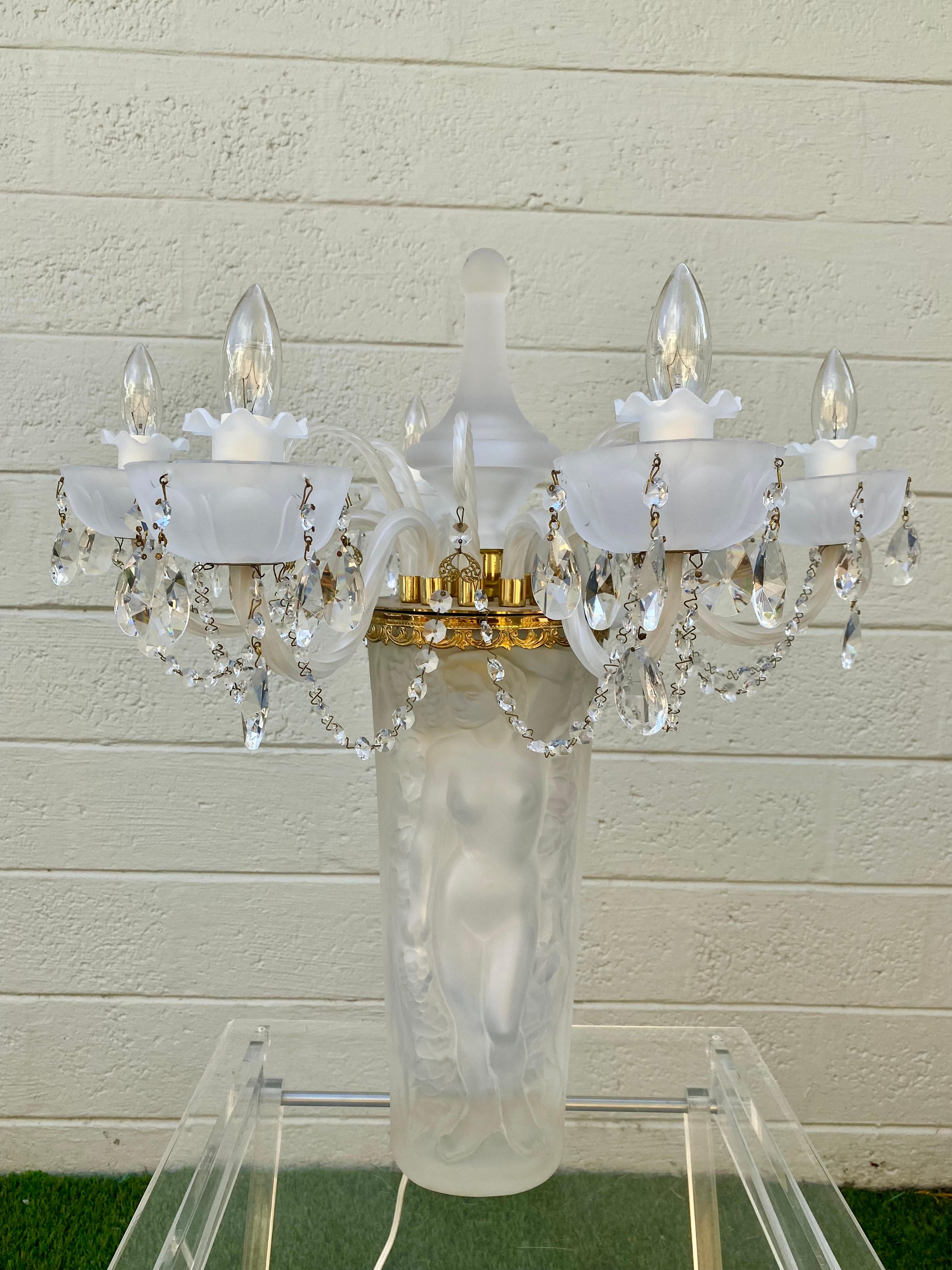 This extremely rare crystal chandelier lamp is packed with personality! Outstanding design is exhibited throughout the monumental form.  Lalique’s boundless imagination and creative genius lead to the creation of the Bacchantes lamp. The iconic