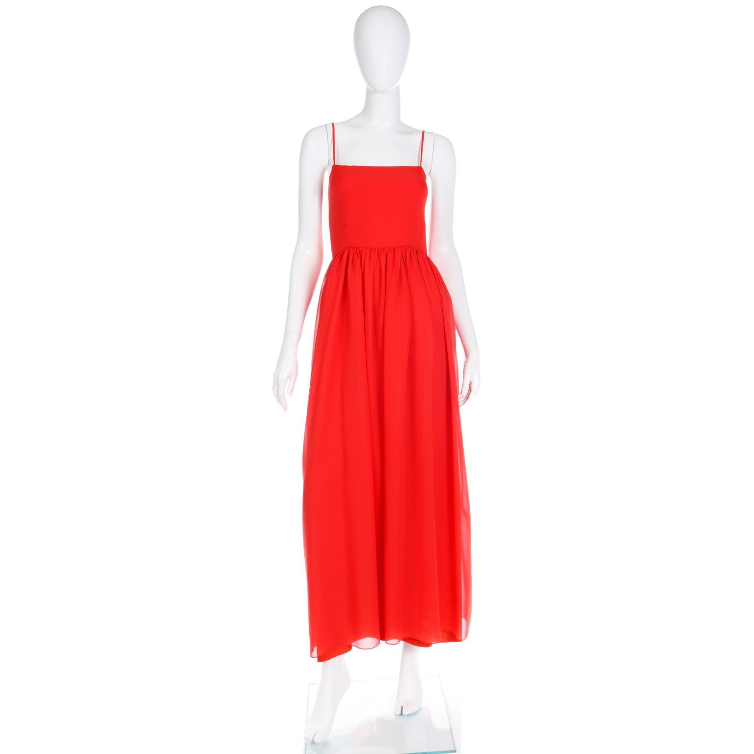 This simple but elegant vintage 1970's Lanvin red silk dress can be worn as an evening gown or a day dress, depending on the accessories and shoes you choose to wear with it. The dress is fitted at the gently gathered waist and it has a crepe lining